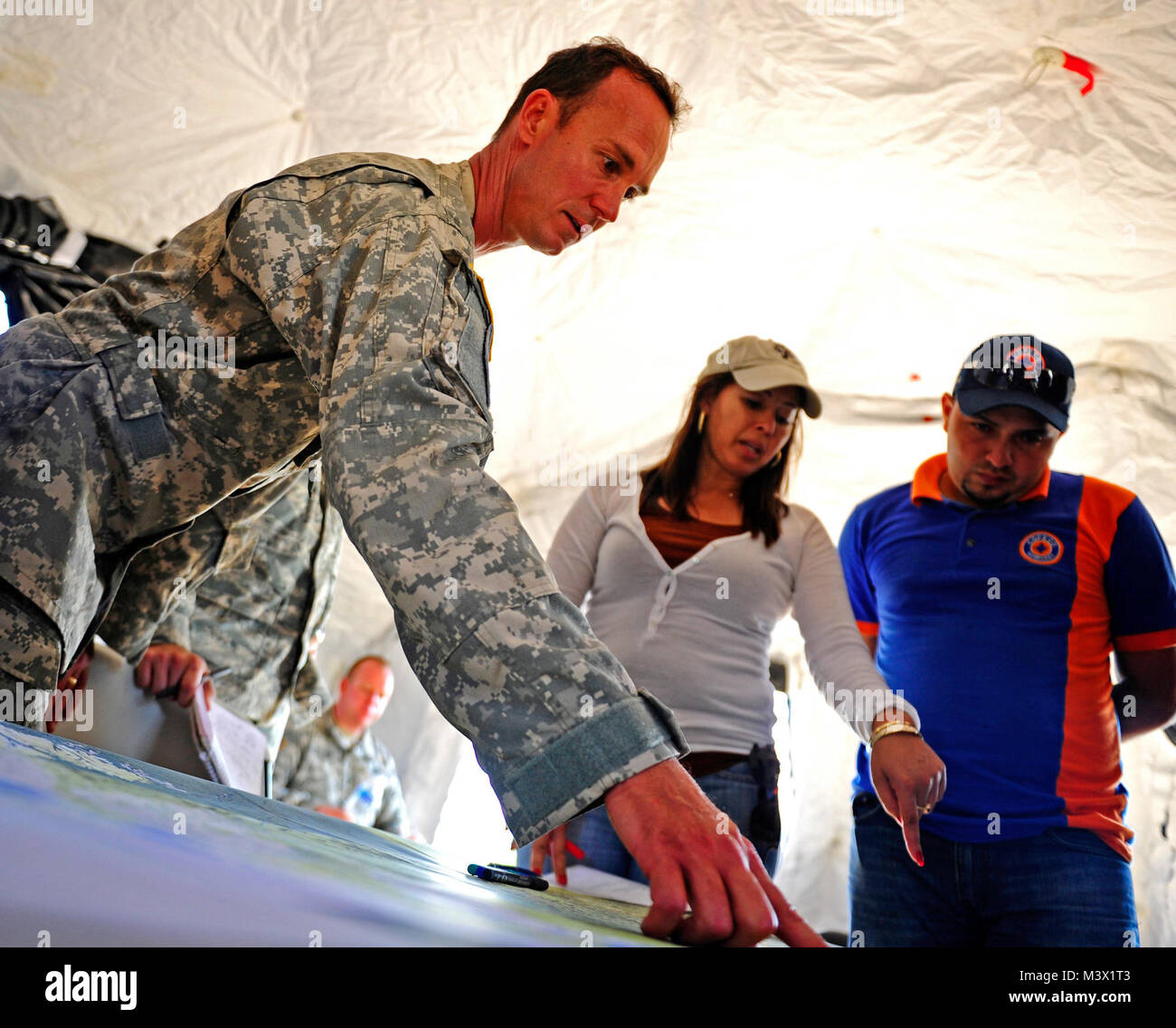 United States Army Chief Warrant Officer Edmond Bessette, CENTAM Survey and Assessment Team member and Iris Medina, C-SAT member identify the location of damage for a simulated hurricane with a Honduran Comision Permanente de Contingencias, during a simulated Hurricane disaster response exercise at Porte Castilla Honduras, May 15. The C-SAT team responds to a natural disaster and humanitarian assistance notification in the Central America Region to conduct an assessment of the area before military forces are deployed.(Air Force photo by Staff Sgt. Eric Donner) 130515-F-GW519-004 by ussouthcom Stock Photo