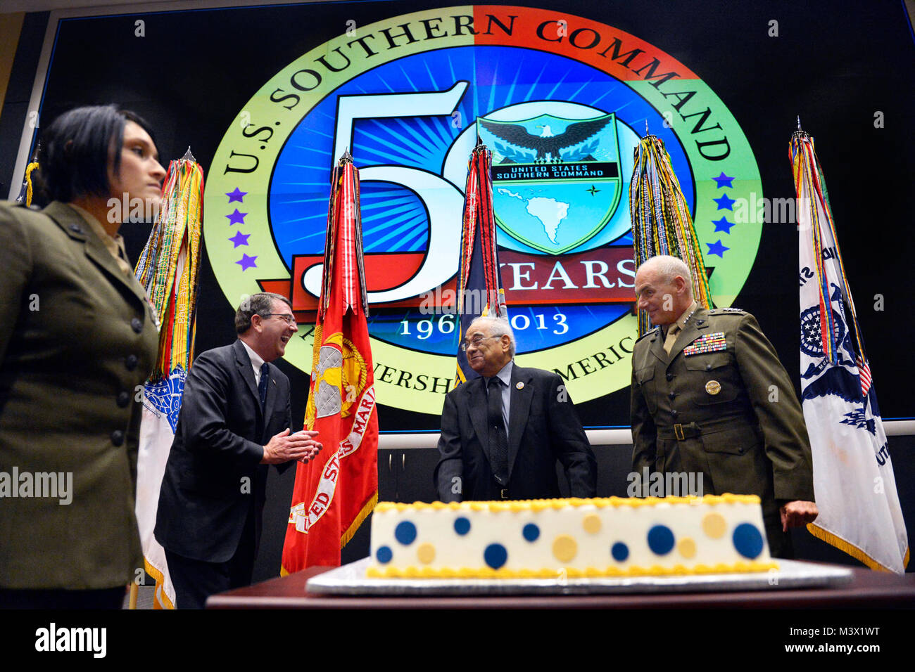 Deputy Secretary of Defense Ashton B. Carter and Gen. John F. Kelly, USMC, commander U.S. Southern Command, share a light moment with SOUTHCOM employee John Samson who was offered the first slice of a cake cut to mark  SOUTHCOM''s 50th anniversary ceremony at SOUTHCOM HQ in Miami, Fla., June 4, 2013. Samson received a letter of appreciation during the ceremony and has served over 50 years in government service, mostly for SOUTHCOM. DoD Photo By Glenn Fawcett (Released) 130604-D-NI589-229 by ussouthcom Stock Photo