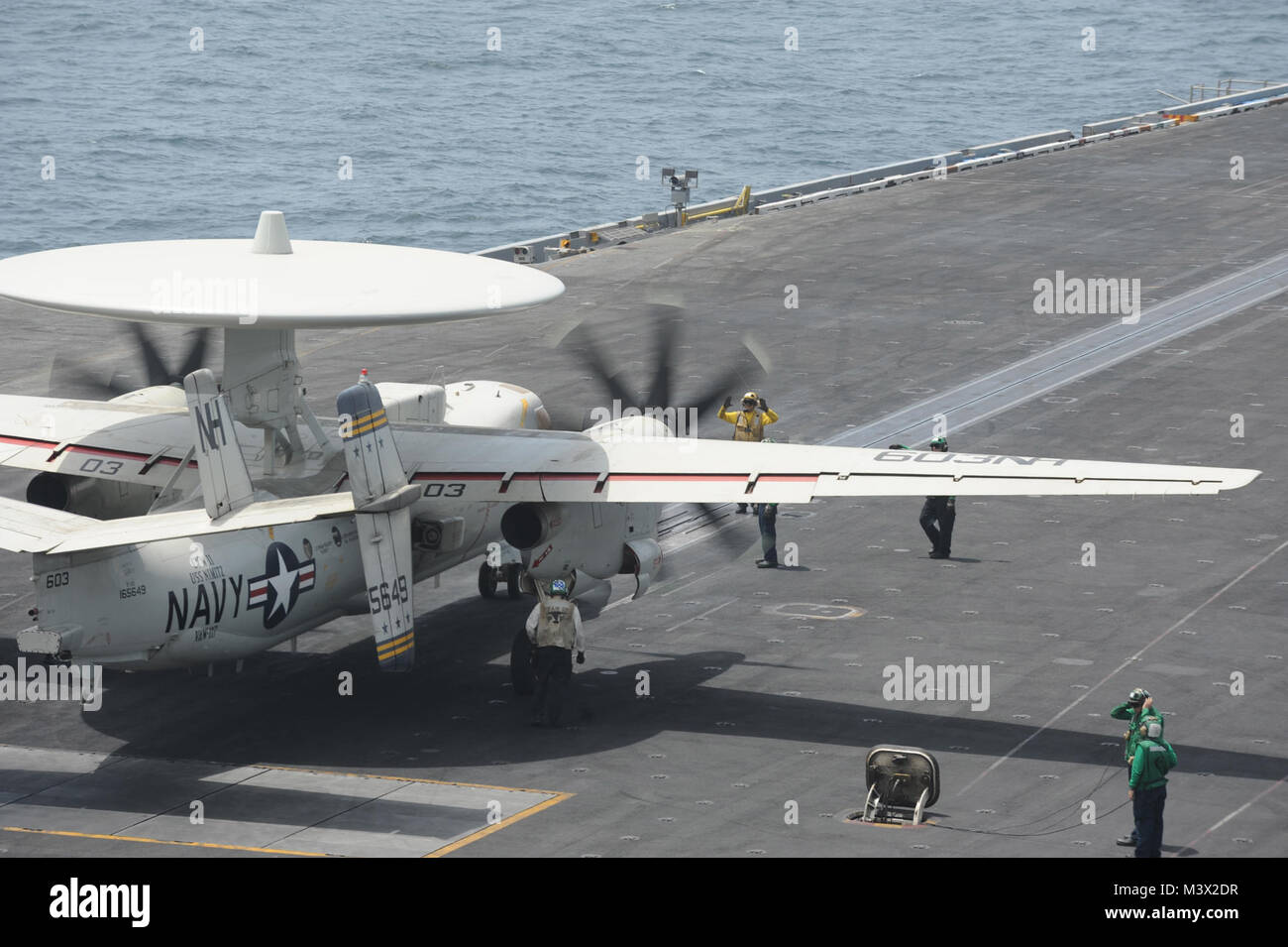 GULF OF OMAN (July 12, 2013) -- An E-2C Hawkeye assigned to the 'Wallbangers' of Carrier Airborne Early Warning Squadron (VAW) 117 gets ready to launch from the flight deck of the aircraft carrier USS Nimitz (CVN 68). Nimitz Strike Group is deployed to the U.S. 5th Fleet area of responsibility conducting maritime security operations, theater security cooperation efforts and support missions for Operation Enduring Freedom.  (U.S. Navy photo by Mass Communication Specialist 3rd Class Chris Bartlett/Released) 13 July Batch 1 of 34 by USS NIMITZ (CVN 68) Stock Photo