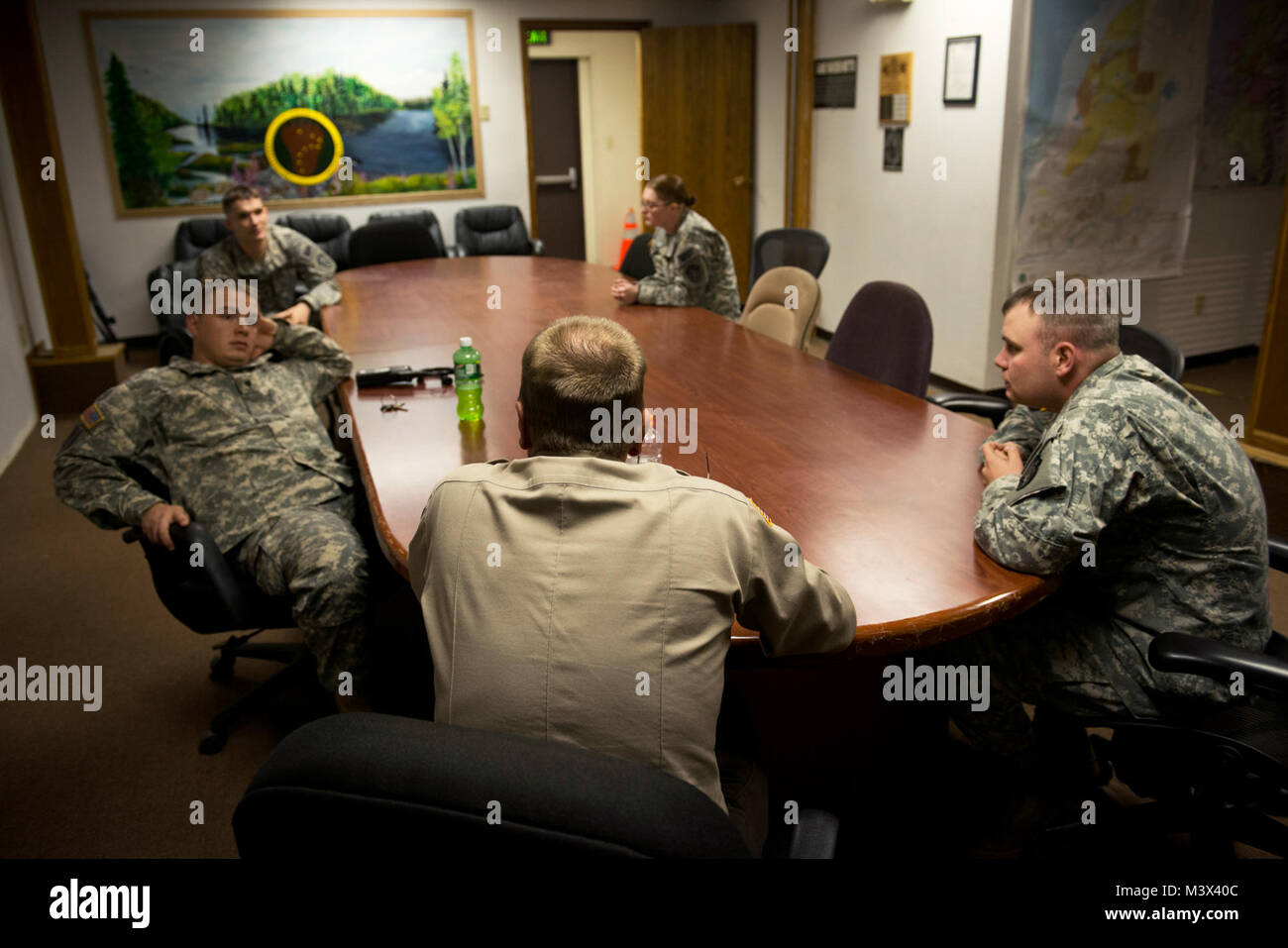 James Wendland meets with Soldiers, who are volunteer military conservation agents, at Joint Base Elmendorf-Richardson, Alaska, to talk the events that happened throughout the day. Wendland works alongside the Soldiers to patrol and protect the base's perimeters and within of any illegal hunting and trapping. (U.S. Air Force photo/Senior Airman Andrew Lee) 130918-F-NL936-721 by AirmanMagazine Stock Photo