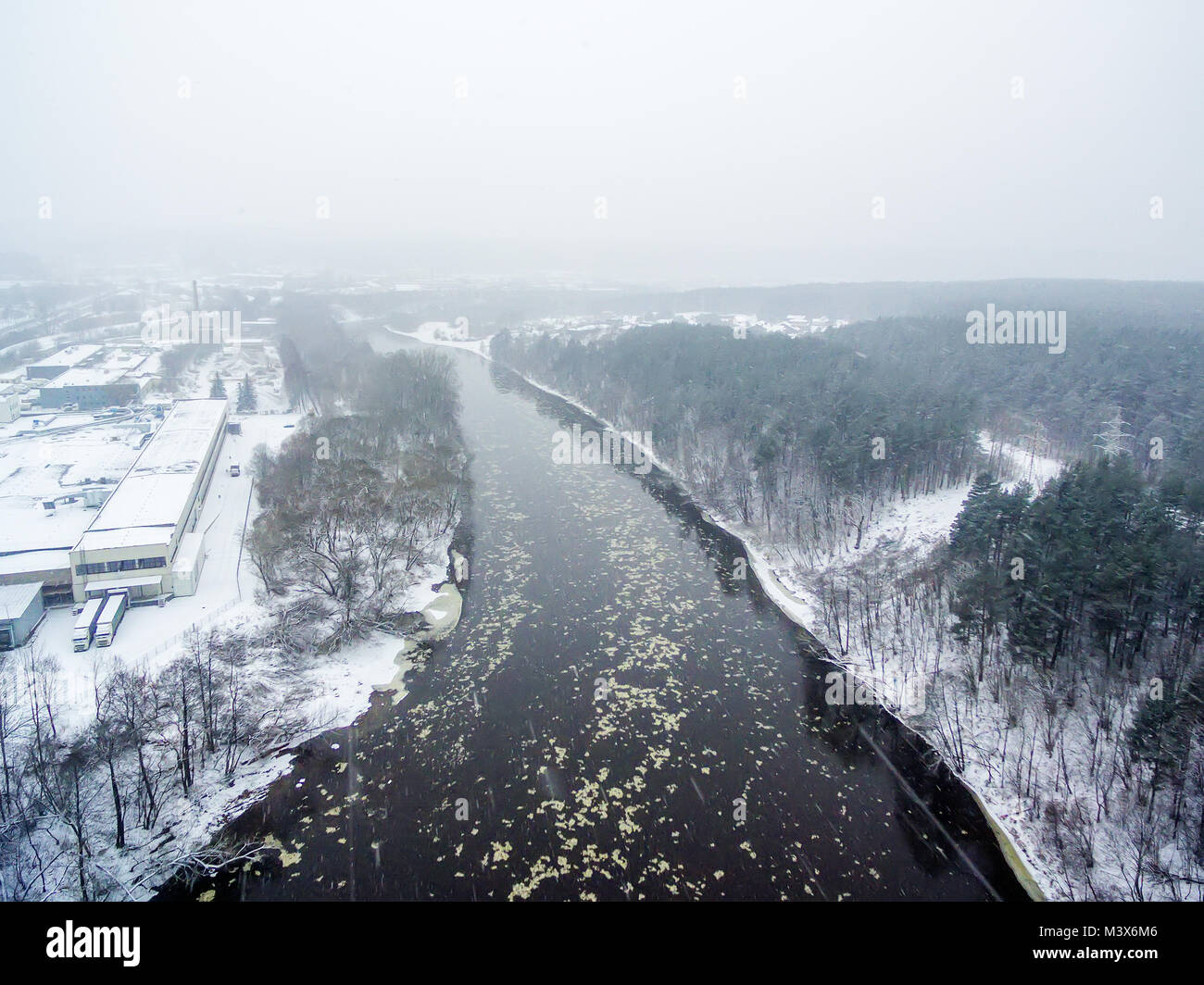It is snowing in Vilnius, Lithuania, aerial top view of Neris river in winter Stock Photo