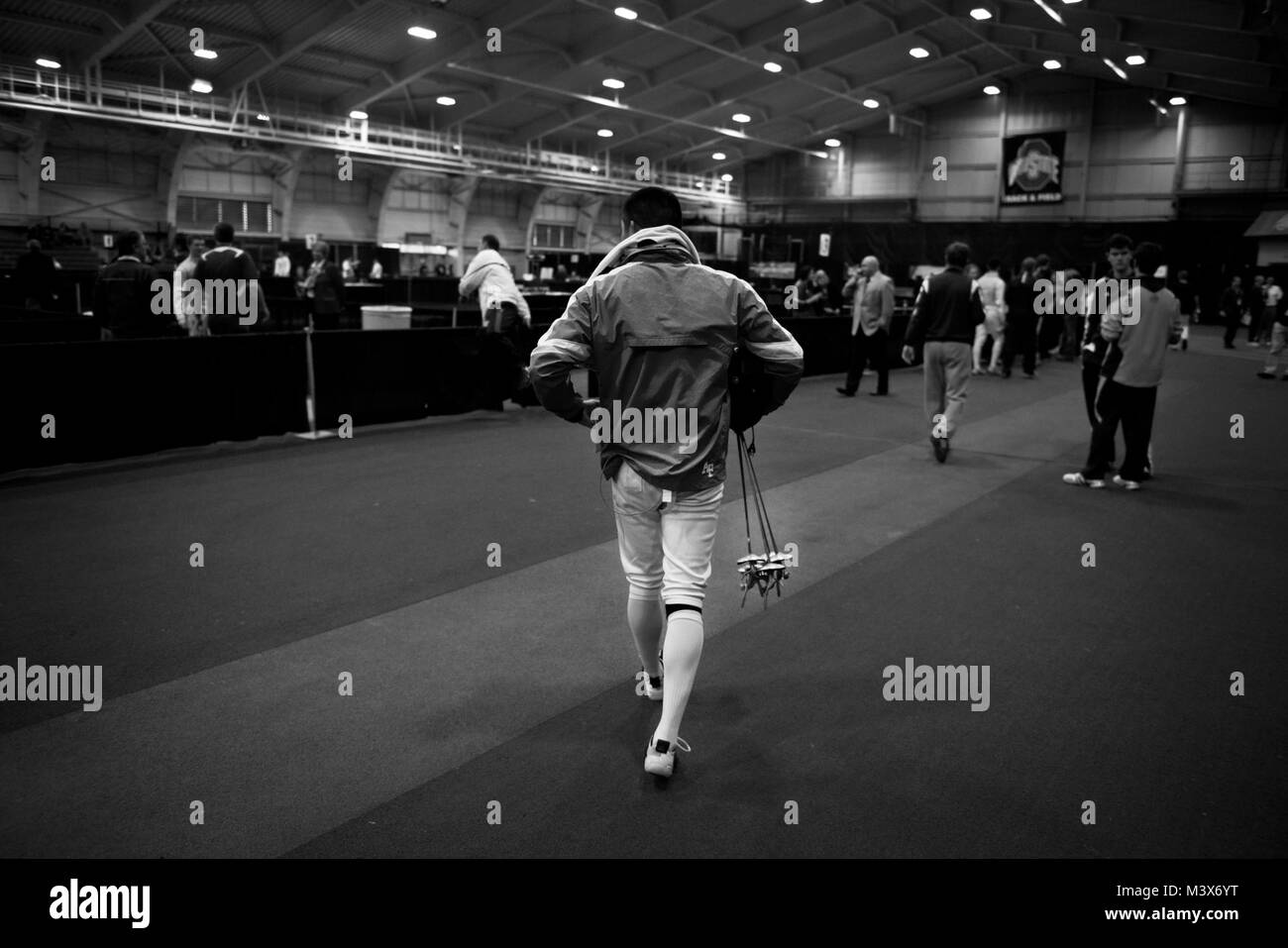 Alexander Chiang takes a handful of foil weapons to warmups prior to ...