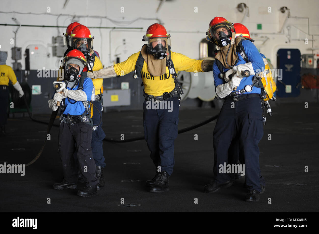 PACIFIC OCEAN (July 25, 2014) Sailors practice firefighting during a drill in the hangar bay of the aircraft carrier USS Nimitz (CVN 68). Nimitz is currently underway conducting routine training and exercises. (U.S. Navy photo by Mass Communication Specialist 3rd Class Siobhana R. McEwen/Released) 140724-N-MX772-056.jpg by USS NIMITZ (CVN 68) Stock Photo