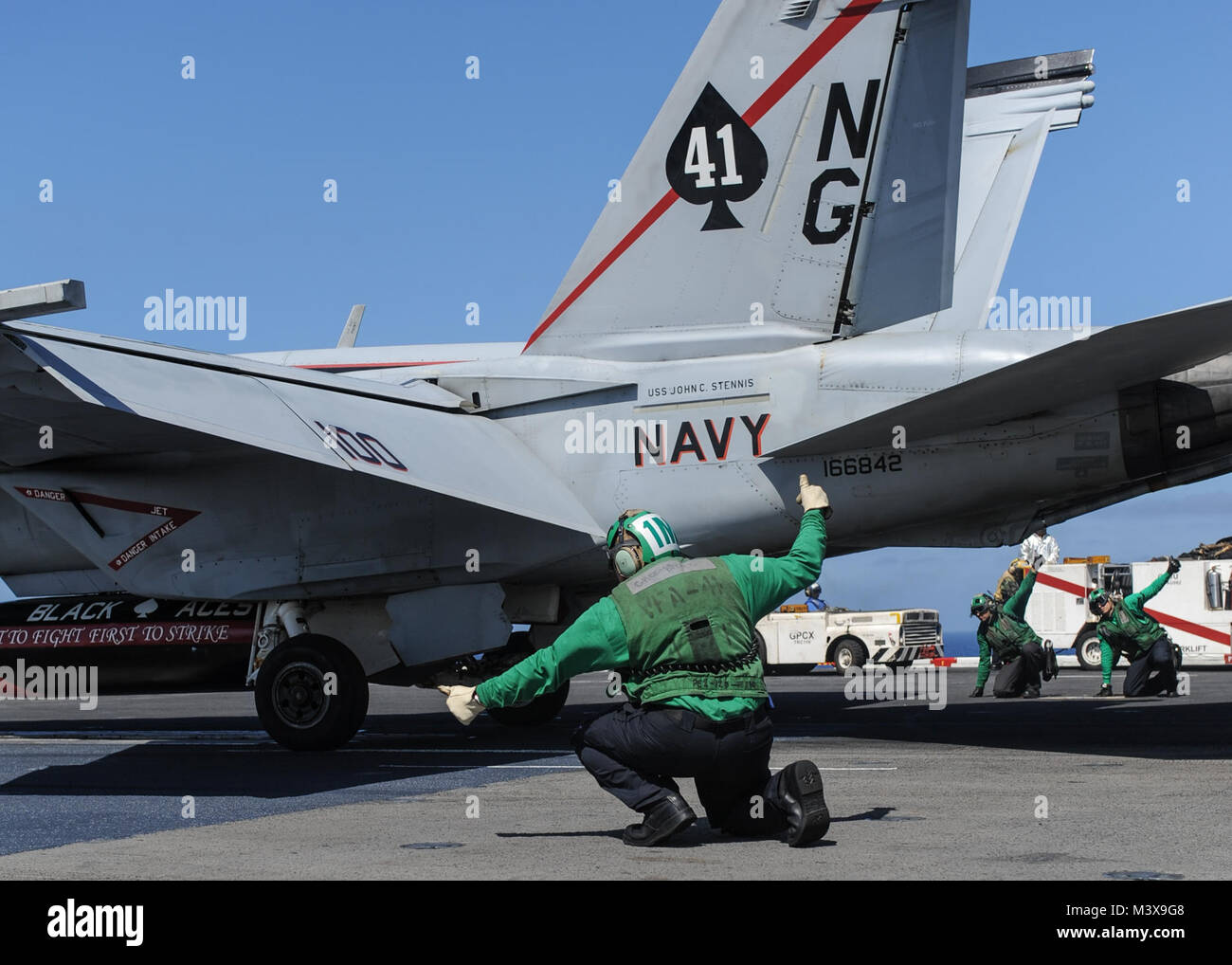 PACIFIC OCEAN (Sept. 11, 2014) Sailors prepare to launch an F/A-18F Super Hornet, assigned to the Black Aces of Strike Fighter Squadron (VFA) 41, from the flight deck of the aircraft carrier USS Nimitz (CVN 68). Nimitz is currently underway conducting routine operations and training exercises. (U.S. Navy photo by Mass Communication Specialist 3rd Class Siobhana R. McEwen/Released) 140911-N-MX772-126.jpg by USS NIMITZ (CVN 68) Stock Photo