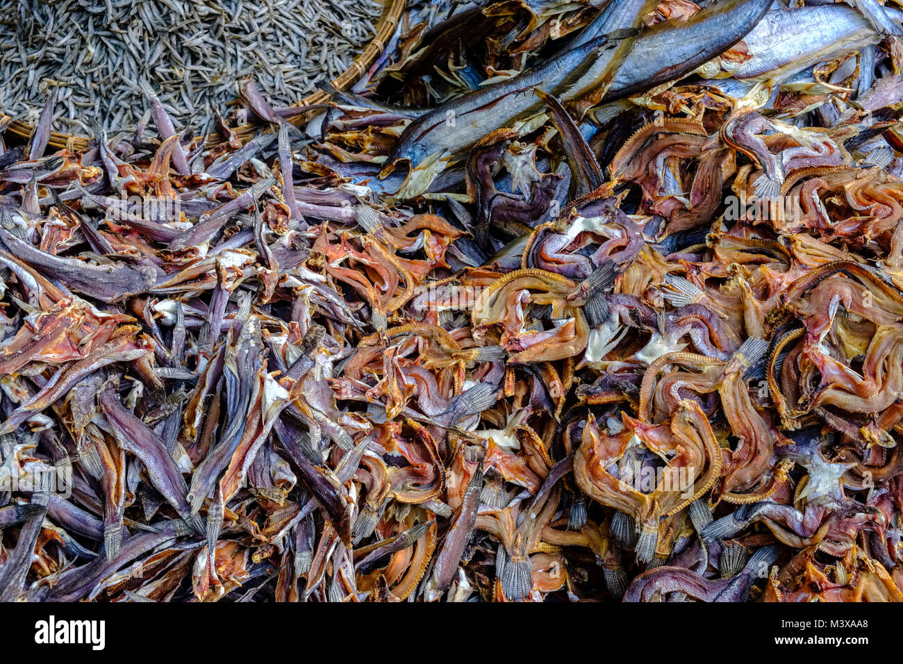 Dried fish, packed in bamboo baskets, is for sale at the vegetable