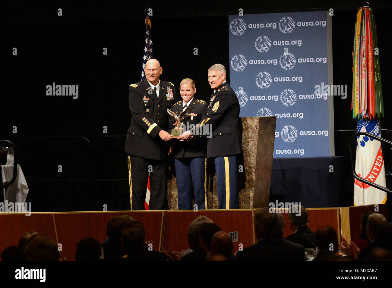 U.S. Army Chief of Staff, Gen. Raymond T. Odierno and Sergeant Major of the Army, SMA Raymond F. Chandler III, award Sgt. Brooke Bailey the Gen. Maxwell Thurman Recruiting Excellence award at the Dwight David Eisenhower Luncheon during 2014 Association of the United States Army (AUSA) annual meeting and exposition held at the Washington Convention Center.  Military and civilian, both foreign and domestic enjoy the many exhibits and conferences offered by AUSA during the three-day convention.  (Department of Defense photo by Marvin Lynchard) 141014-D-FW736-014 by DoD News Photos Stock Photo