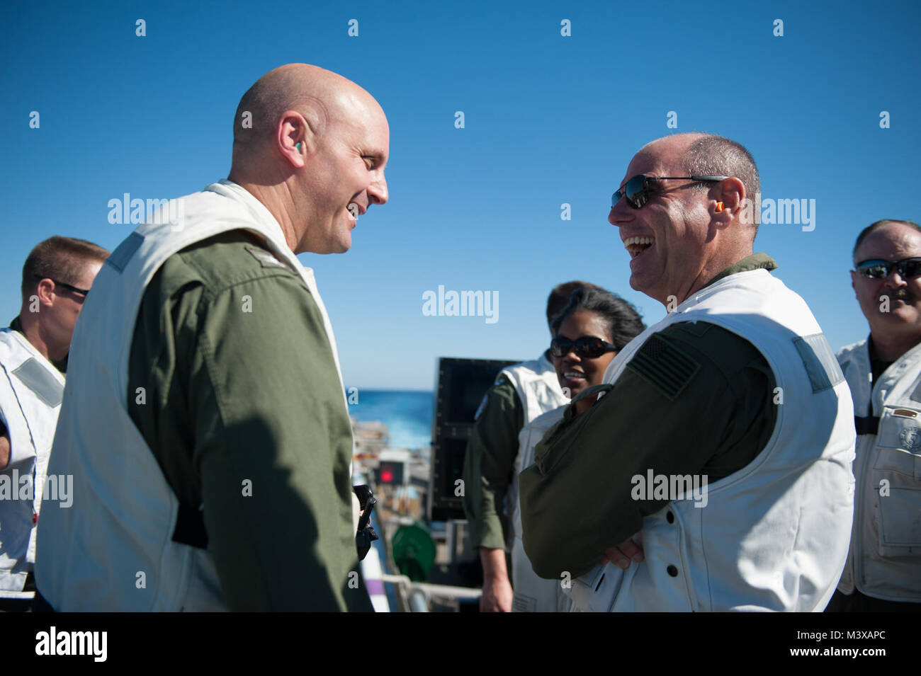 PACIFIC OCEAN (Nov. 3, 2014) Vice Adm. Dave Buss, Commander, Naval Air Forces, right, talks to Capt. J.J. Cummings, executive officer of the aircraft carrier USS Nimitz (CVN 68), after observing an F-35C Lightening II carrier variant Joint Strike Fighter conduct its first arrested landing aboard Nimitz. Nimitz is currently underway conducting routine training exercises. (U.S. Navy photo by Mass Communication Specialist 3rd Class Kelly M. Agee/Released) 141103-N-MX772-245.jpg by USS NIMITZ (CVN 68) Stock Photo