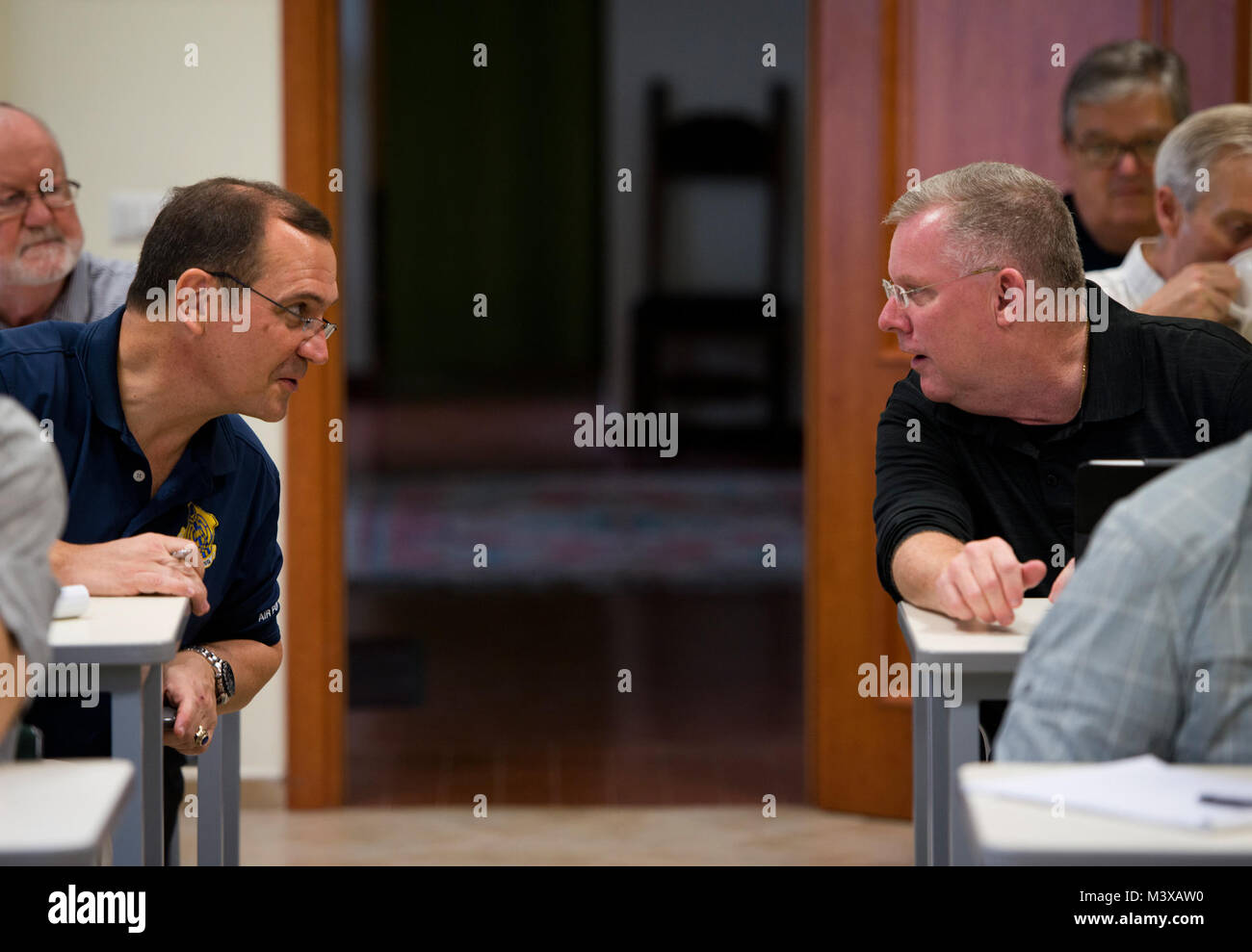 Retired Chaplains (Lt. Col.) Stephen Voyt (left) and (Lt. Col.) Kerry  Abbott finish their conversations before class starts. (. Air Force  photo/Staff Sgt. Andrew Lee) 141106-F-NL936-019 by AirmanMagazine Stock  Photo - Alamy