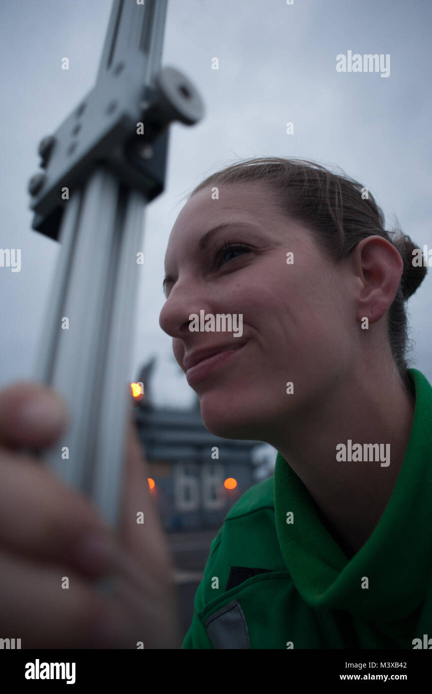 PACIFIC OCEAN (Nov. 11, 2014) Interior Communications Electrician 3rd Class Samantha Polson, from Austin, Texas, performs a pole check on the flight deck of the aircraft carrier USS Nimitz (CVN 68). The F-35 Lightning II Pax River Integrated Test Force from Air Test and Evaluation Squadron (VX) 23 is currently conducting initial at-sea trials aboard Nimitz. (U.S. Navy photo by Mass Communication Specialist Seaman Apprentice Kole E. Carpenter) 141110-N-JC752-143.jpg by USS NIMITZ (CVN 68) Stock Photo