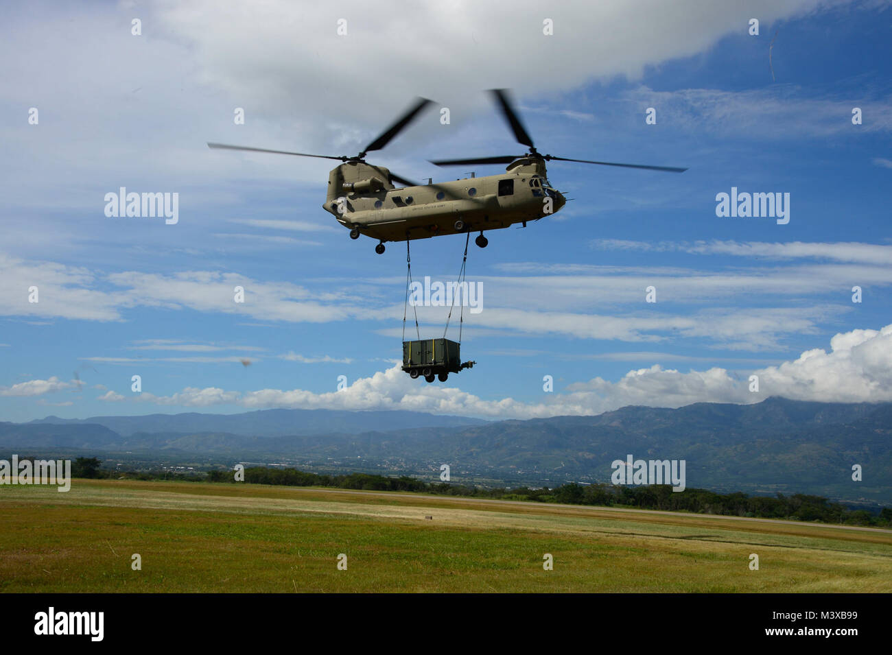 A CH-47 Chinook flies a container to the Warrior Ramp during air load ...