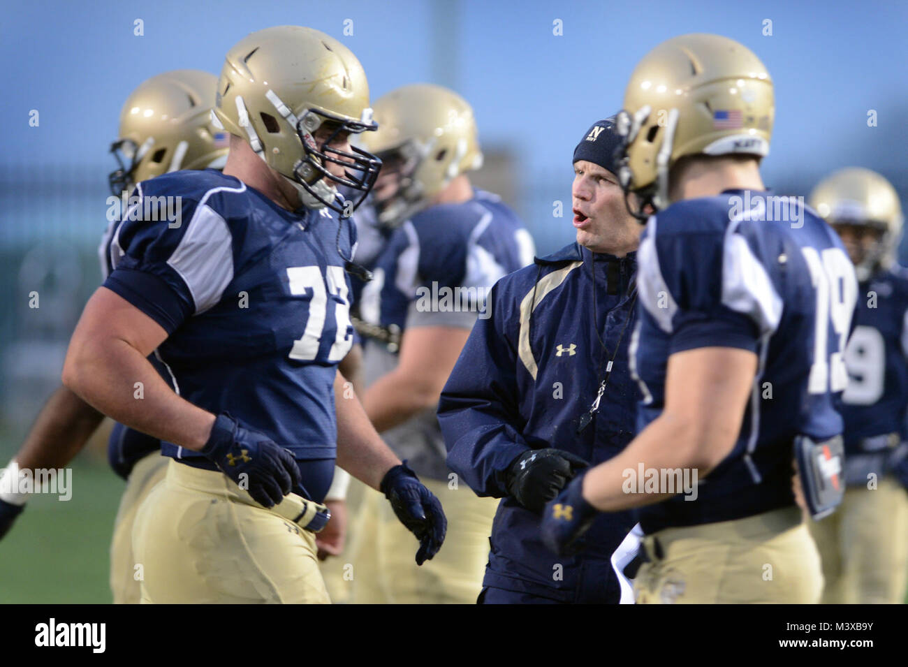 141203-D-FW736-018 –Ashley Ingram, Naval Academy offensive line coach,  gives instruction to Sophomore offensive guard, Adam West, a member of the  Navy midshipmen football team, as the team prepares for the 115th annual