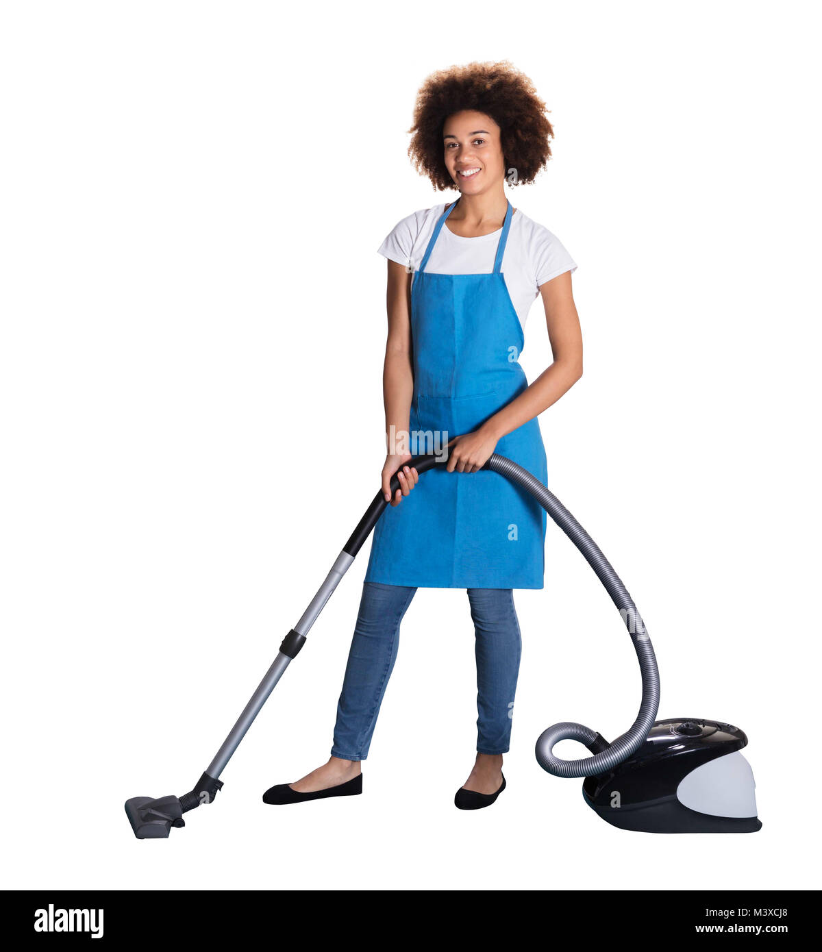 Portrait Of A Happy Female Janitor With Vacuum Cleaner On White Background Stock Photo