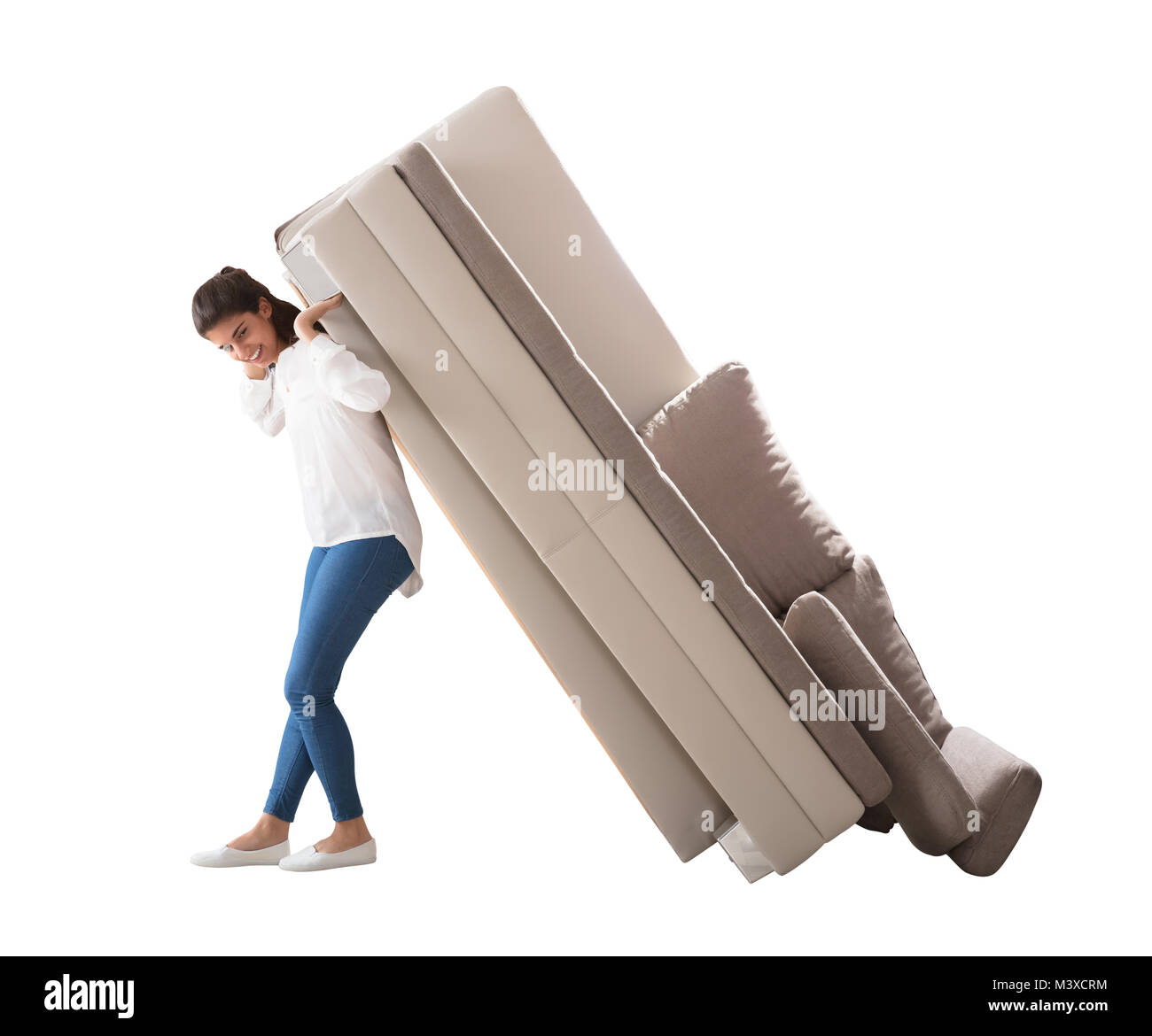 Side View Of A Happy Young Woman Lifting Sofa On White Background Stock Photo