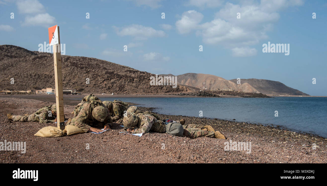 U.S. Army Soldiers assigned to Combined Joint Task Force - Horn of Africa plot grid points during land navigation training in preparation for an Expert Infantryman Badge evaluation at Arta Range, Djibouti, Jan. 25, 2018. After two weeks of training and five days of testing, 50 Soldiers completed the process to earn the coveted special skills badge that requires Soldiers to perform an Army Physical Fitness Test, day and night land navigation, a 12-mile forced march, and 30 individual tasks covering weapons, medical, and security patrol skills. (U.S. Air Force photo by Staff Sgt. Timothy Moore) Stock Photo