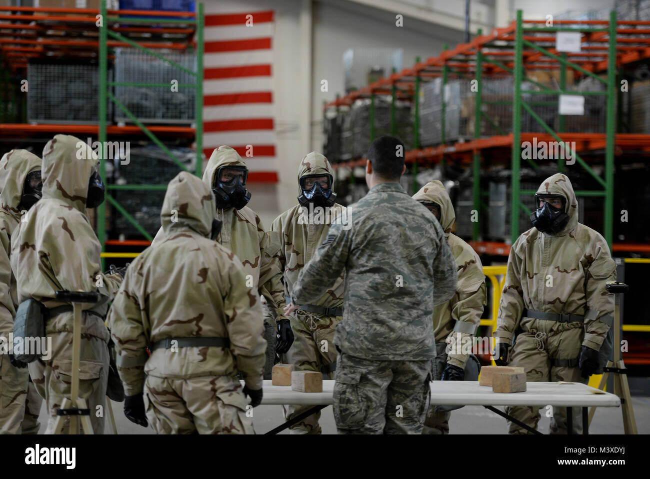 Airmen of Team Dover receive instruction during a Chemical, Biological, Radiological and Nuclear (CBRN) training session Jan. 31, 2018, at Dover Air Force Base, Del. During a suspected CBRN attack, all activities must be accomplished in the Mission Oriented Protective Posture, or MOPP gear, seen in the photo. (U.S. Air Force photo by Staff Sgt. Aaron J. Jenne) Stock Photo