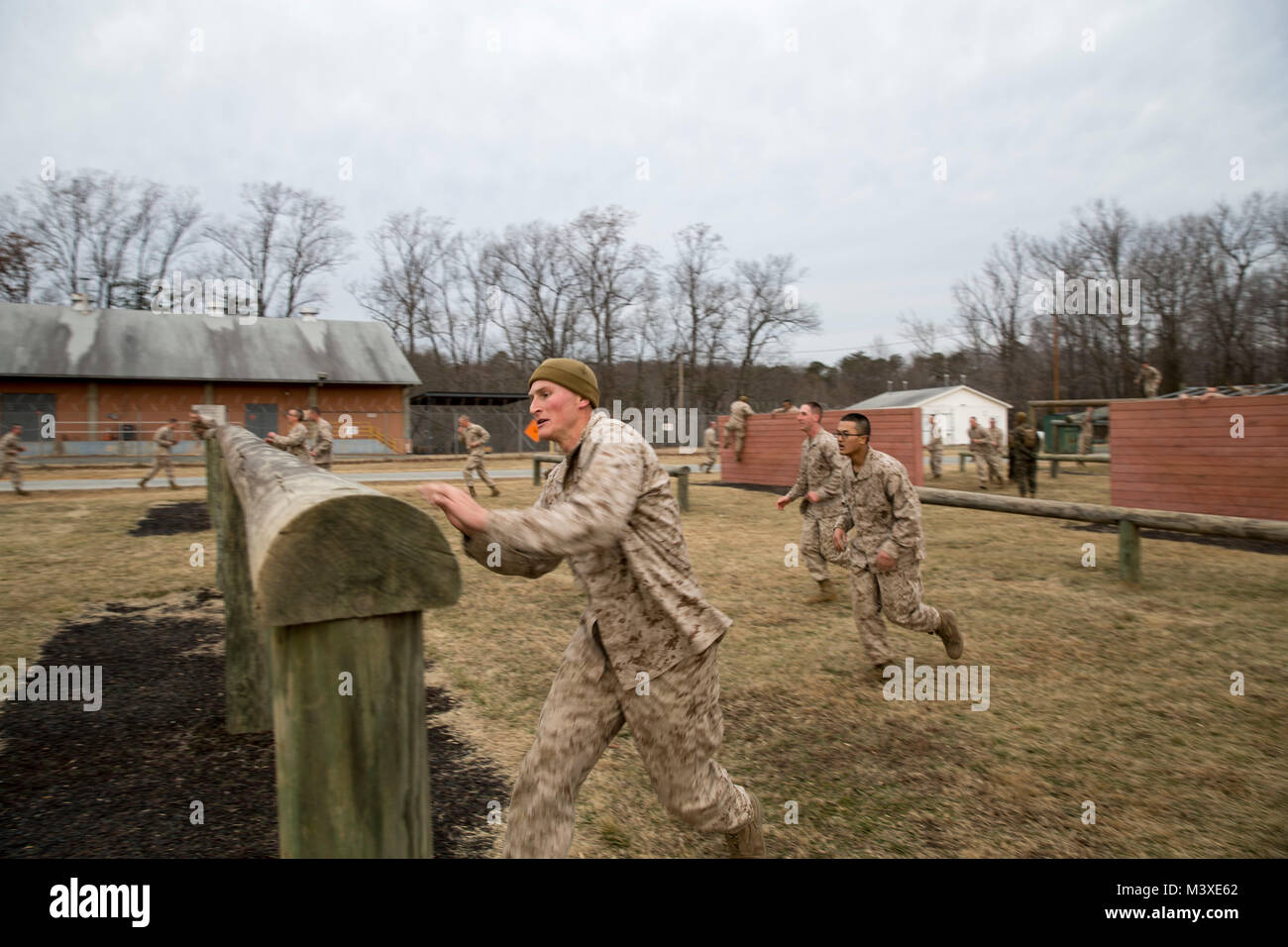 U.S. Marine Corps officer candidates participate in an obstacle course event, at Officer Candidate School, Quantico, Va., Feb. 1, 2018. Candidates must go through three months of intensive training to evaluate and screen individuals for the leadership, moral, mental, and physical qualities required for commissioning as a U.S. Marine Corps officer. (U.S. Marine Corps Photo by Cpl. Brooke Deiters) Stock Photo