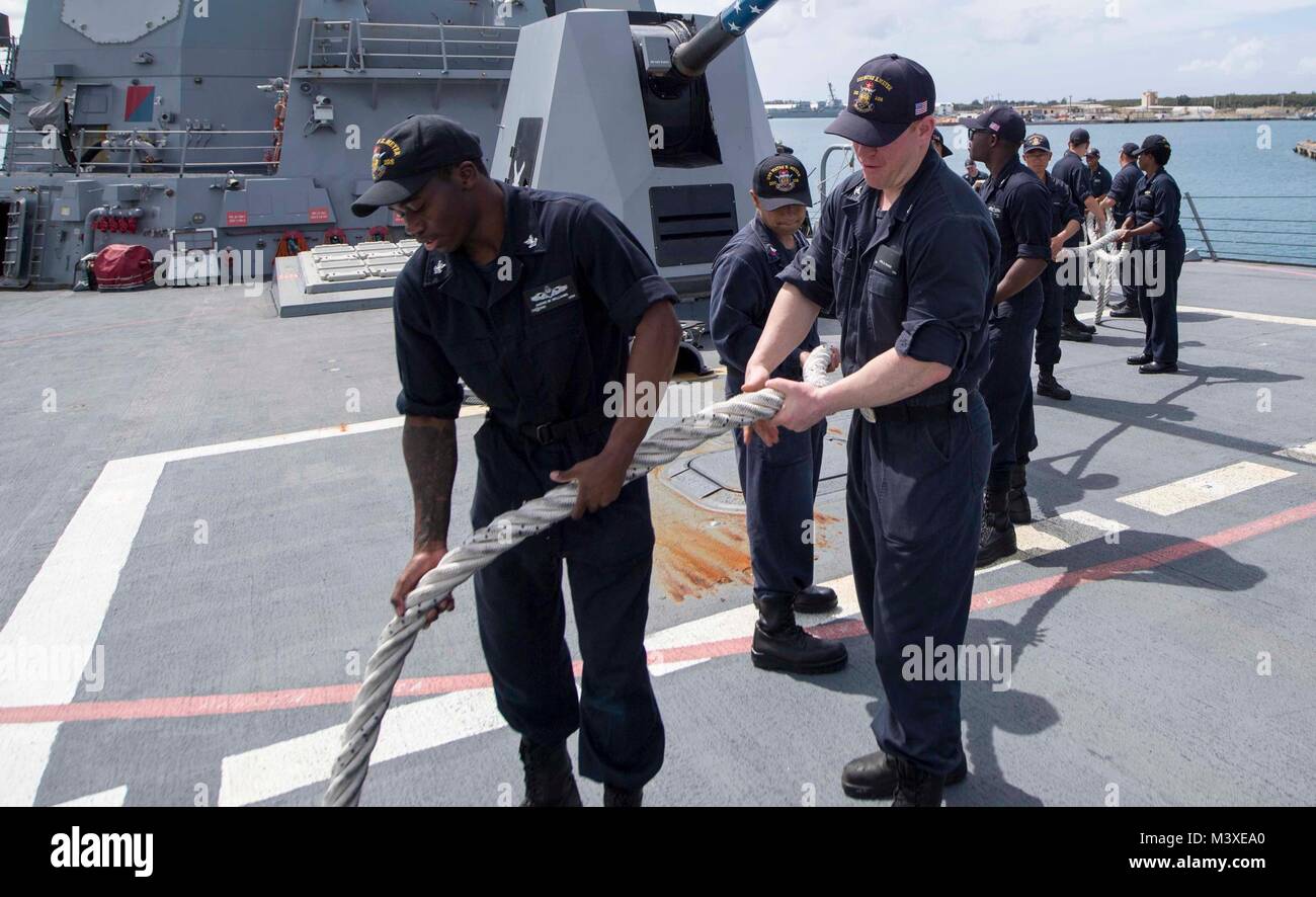 180203-N-BN355-0024  PACIFIC OCEAN (Feb 03,2018) Operations specialist 3rd class Andre Williams and Cryptologic technician Joel Rither help stow line aboard Arleigh Burke-class guided-missile destroyer USS Wayne E. Meyer (DDG 108) as the ship departs Naval Base Guam. Wayne E. Meyer is currently operating in the Pacific as part of the Carl Vinson Strike Group. (U.S. Navy photo by Mass Communication Specialist Seaman Jailene Casso/ Released) Stock Photo