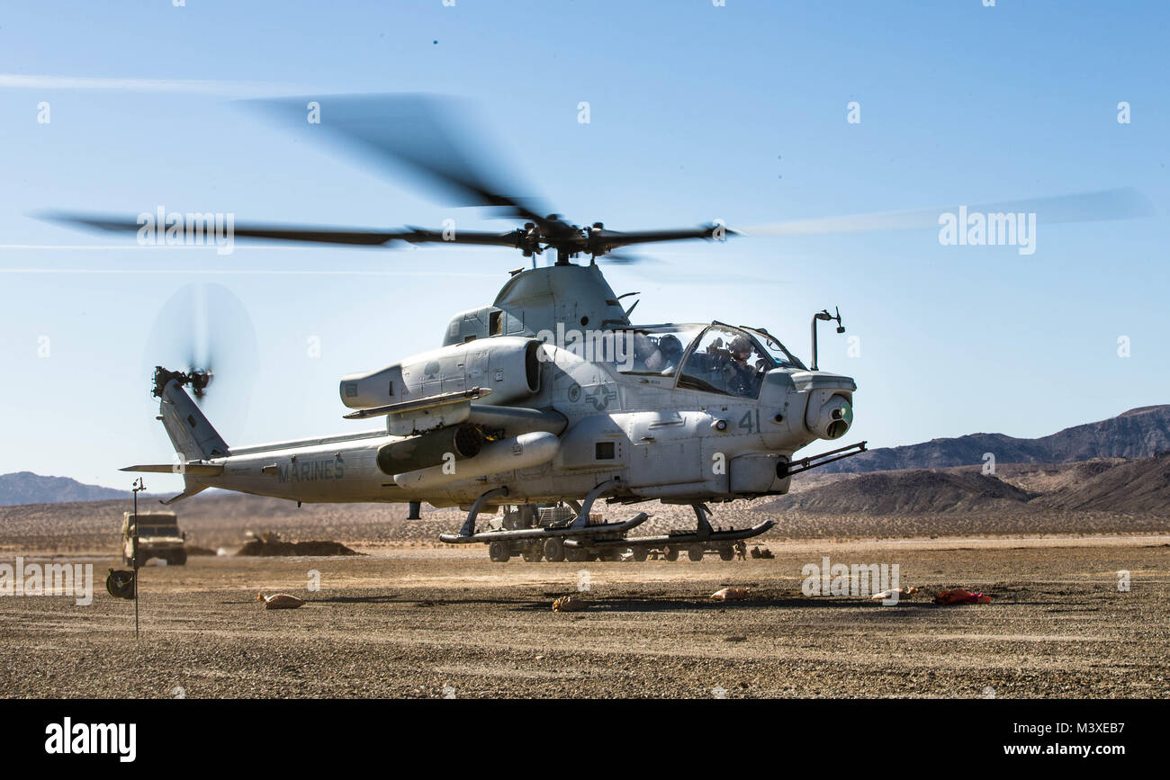 A Bell AH-1Z Viper takes off at a Forward Arming and Refueling Point at Marine Corps Air Ground Combat Center, Twentynine Palms, Calif., Feb. 4, 2018, as a part of Integrated Training Exercise 2-18. The purpose of ITX is to create a challenging, realistic training environment that produces combat-ready forces capable of operating as an integrated MAGTF. (U.S. Marine Corps Photo by Pfc. William Chockey) Stock Photo