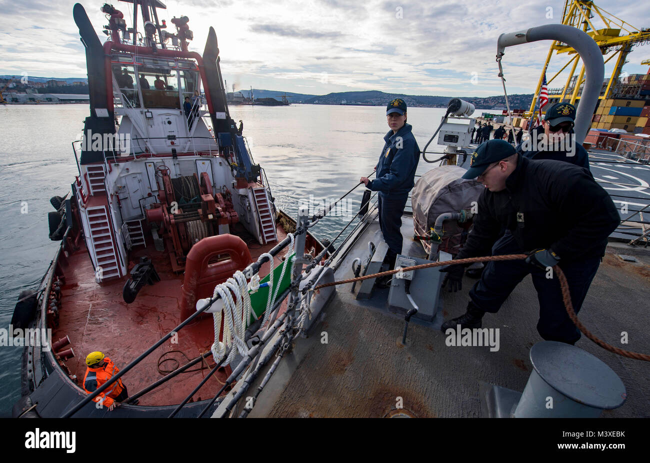 180204-N-RG482-052  TRIESTE, Italy (Feb. 4, 2018) Sailors aboard the Arleigh Burke-class guided-missile destroyer USS Ross (DDG 71) haul line aboard the ship while departing Trieste, Italy. Ross, forward-deployed to Rota, Spain, is on its sixth patrol in the U.S. 6th Fleet area of operations in support of regional allies and partners and U.S. national security interests in Europe. (U.S. Navy photo by Mass Communication Specialist 1st Class Kyle Steckler/Released) Stock Photo