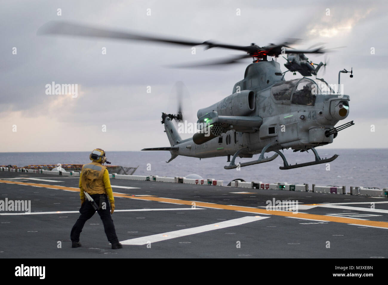 180204-N-XK809-047  PHILIPPINE SEA (Feb. 4, 2018) An AH-1Z Viper helicopter assigned to the 'Gunfighters' of Marine Light Attack Helicopter Squadron (HMLA) 369 lands on the flight deck of the amphibious assault ship USS Bonhomme Richard (LHD 6). Bonhomme Richard is operating in the Indo-Asia-Pacific region as part of a regularly scheduled patrol and provides a rapid-response capability in the event of a regional contingency or natural disaster. (U.S. Navy photo by Mass Communication Specialist 2nd Class William Sykes/Released) Stock Photo