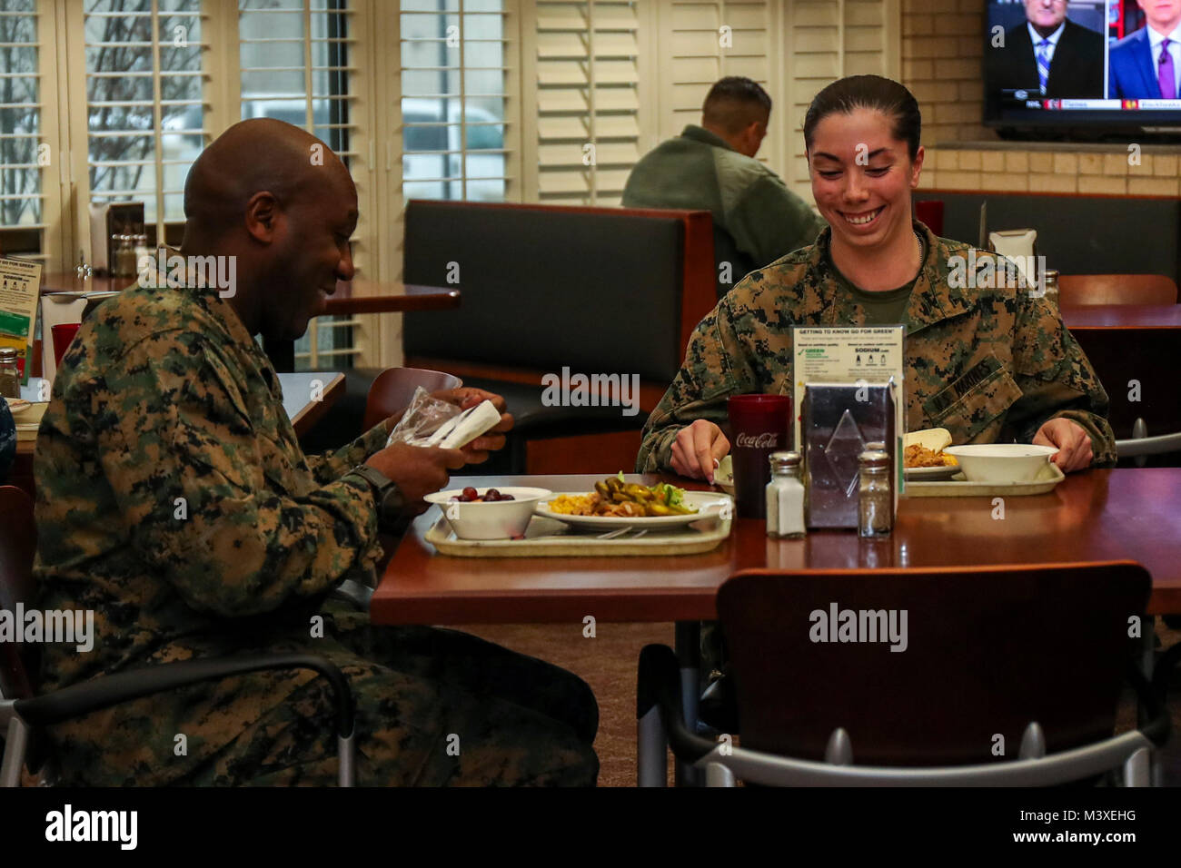 U.S. Marine Corps Sgt. Maj. Ronald L. Green, Sgt. Maj. of the Marine Corps, and Lance Cpl. Jordan Tarnowske, an out bound administration clerk with 8th Marine Corps Recruiting District, eat afternoon chow on Naval Air Station Joint Reverse Base on February 6, 2018. The 8th Marine Corps Recruiting District is the largest district, covering over 1 million square miles in 13 states. (U.S. Marine Corps photo by Sgt. Clarence A. Leake) Stock Photo