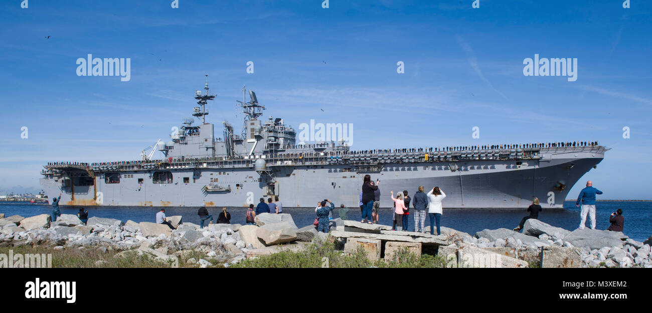 180207-N-TP832-027 JACKSONVILLE, Fla. (Feb. 7, 2018) Family members observe as the amphibious assault ship USS Iwo Jima (LHD 7) departs Naval Station Mayport for a scheduled six-month deployment. The Iwo Jima Amphibious Assault Ready Group and the 26th Marine Expeditionary Unit are deploying to conduct maritime security operations, crisis response and theater security cooperation, while also providing a forward naval presence in Europe and the Middle East. (U.S. Navy photo by Mass Communication Specialist 2nd Class Michael Lopez/Released) Stock Photo