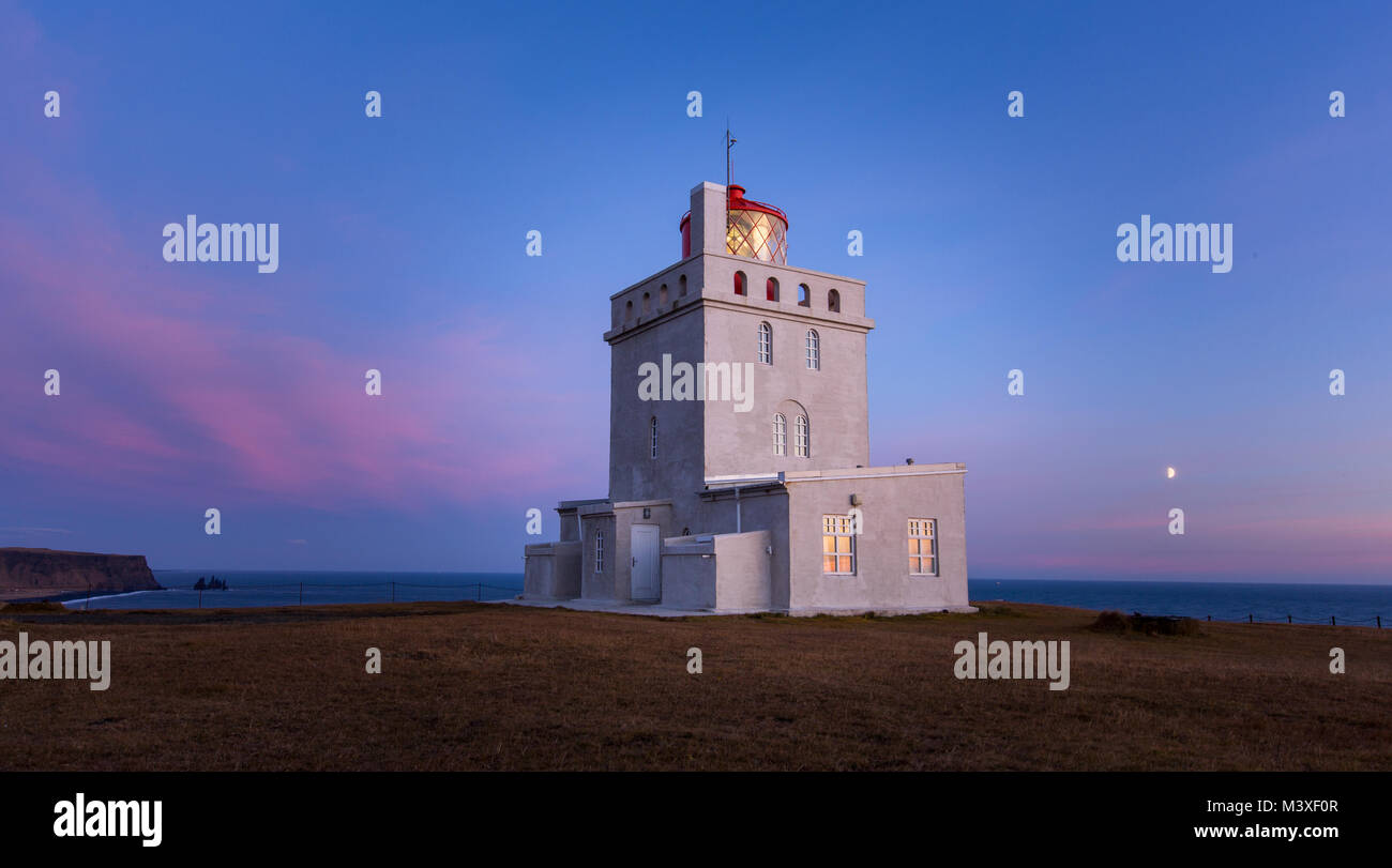 White lighthouse at southern iceland coast dyrholaey Stock Photo