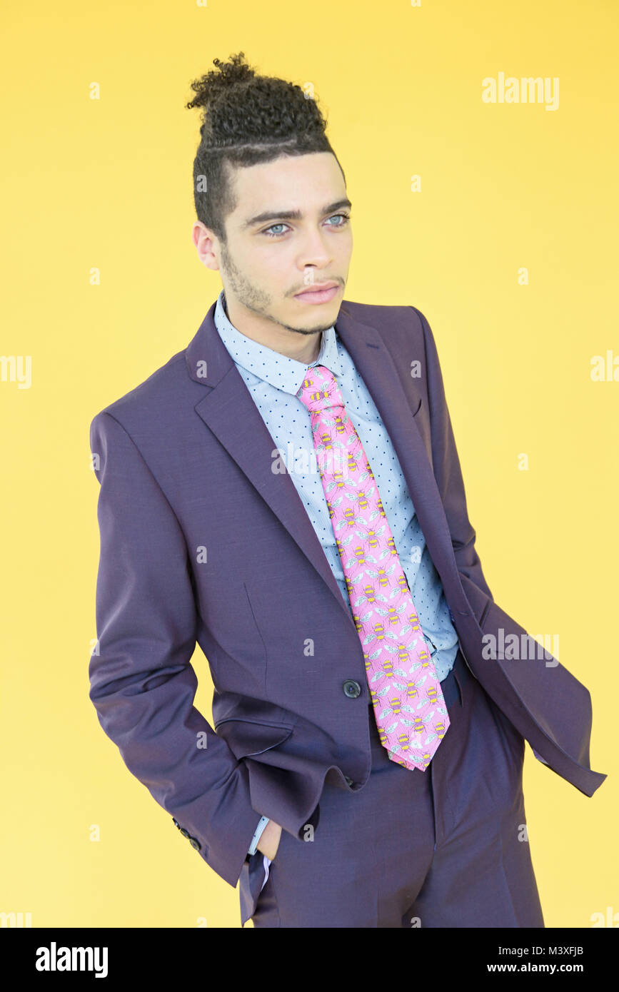 Handsome mixed race young man in a trendy purple suit isolated on