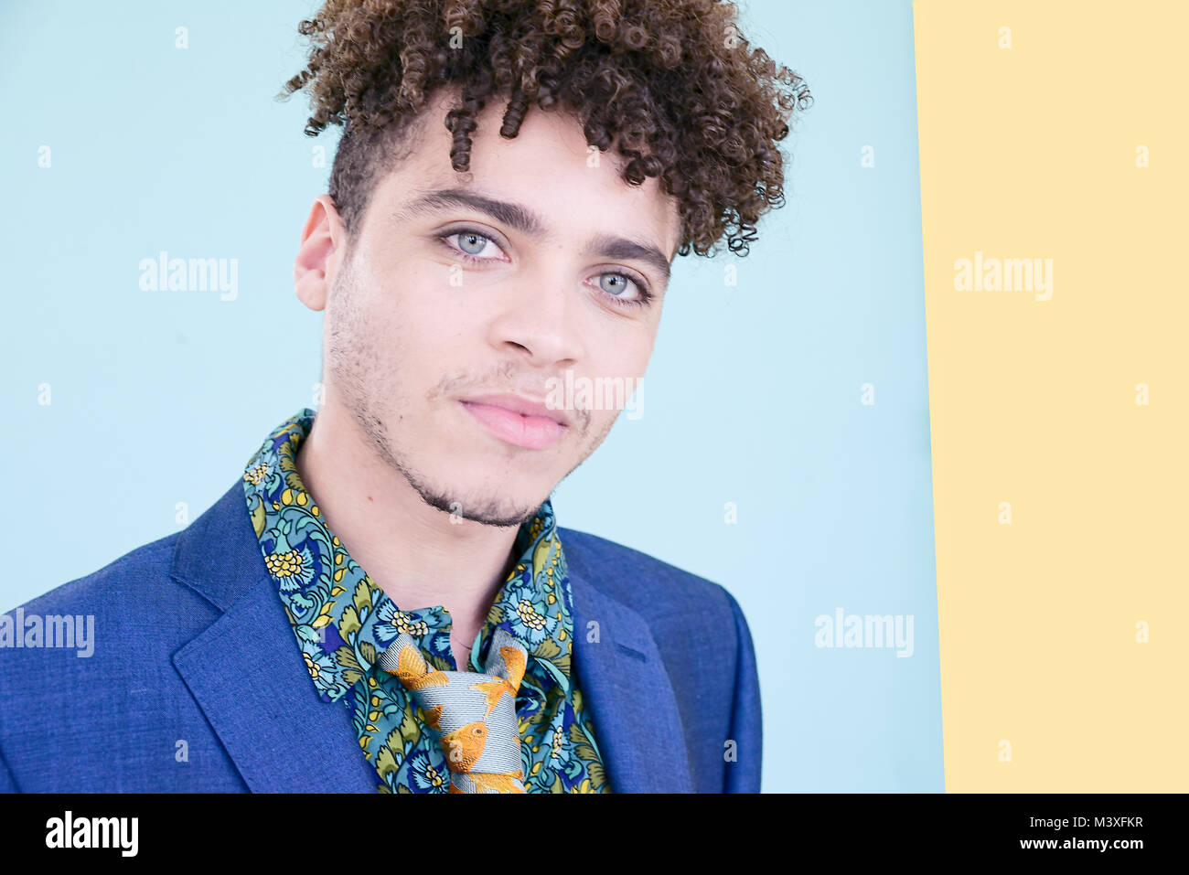 Portrait Of A Handsome Mixed Race Young Man Wearing A Blue Suit