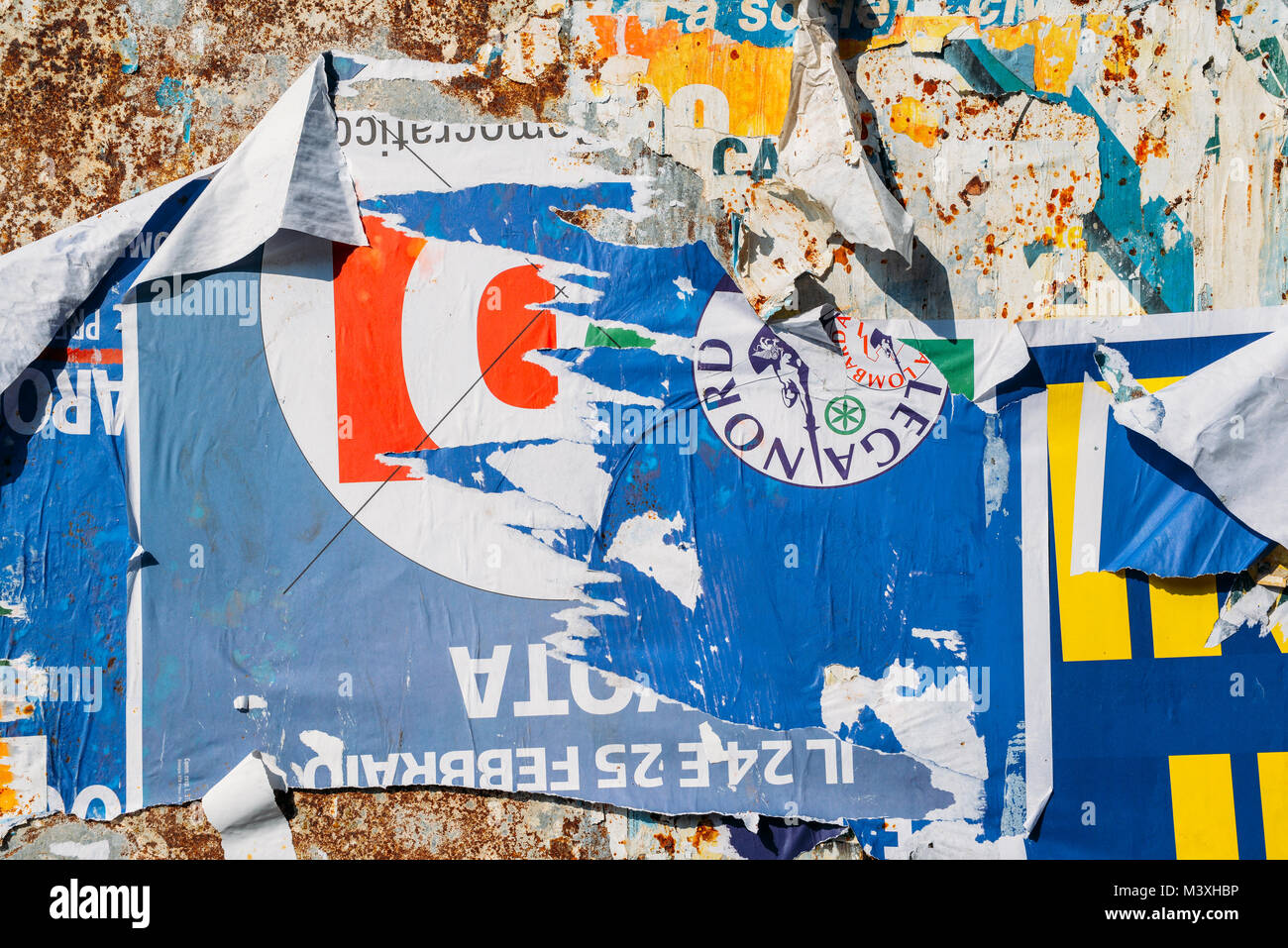 Milan, Italy - Feb 10, 2018: Ripped up billboards ahead of  2018 Italian general election is due to be held on March 4th, 2018 Stock Photo