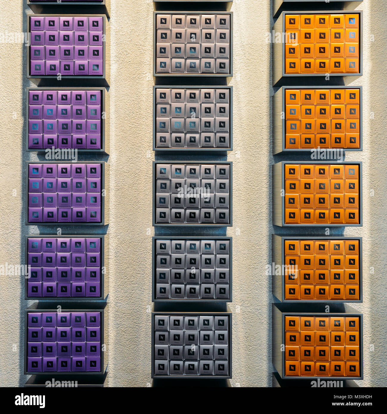 Milan, Italy - Feb 10, 2018: Nespresso coffee capsules of various flavours on display on wall of Nespresso shop in Milan, Italy Stock Photo