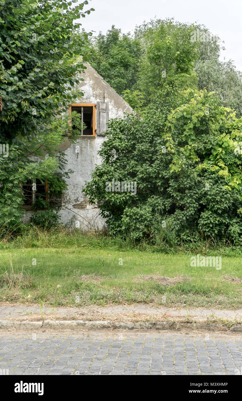 Gable of an old, gray uninhabited house in the countryside Stock Photo