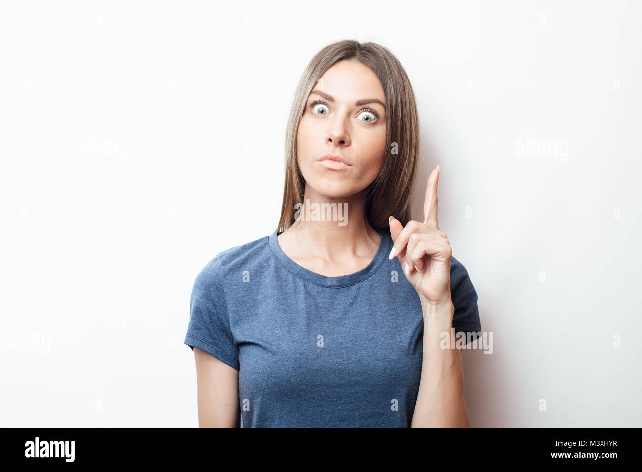 Success, idea and innovation technology concept. Thinking woman looking up with light idea above head isolated on white wall background Stock Photo