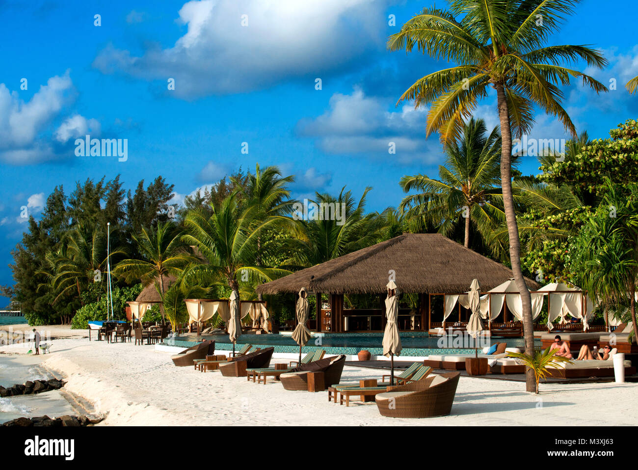 Swimming pool and restaurant in The Residence Hotel and Resort, Gaafu Alifu Atoll. Maldives Islands. Stock Photo