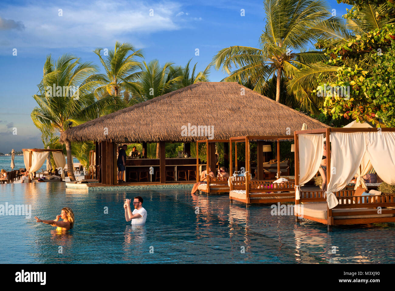 Swimming pool and restaurant in The Residence Hotel and Resort, Gaafu Alifu Atoll. Maldives Islands. Stock Photo