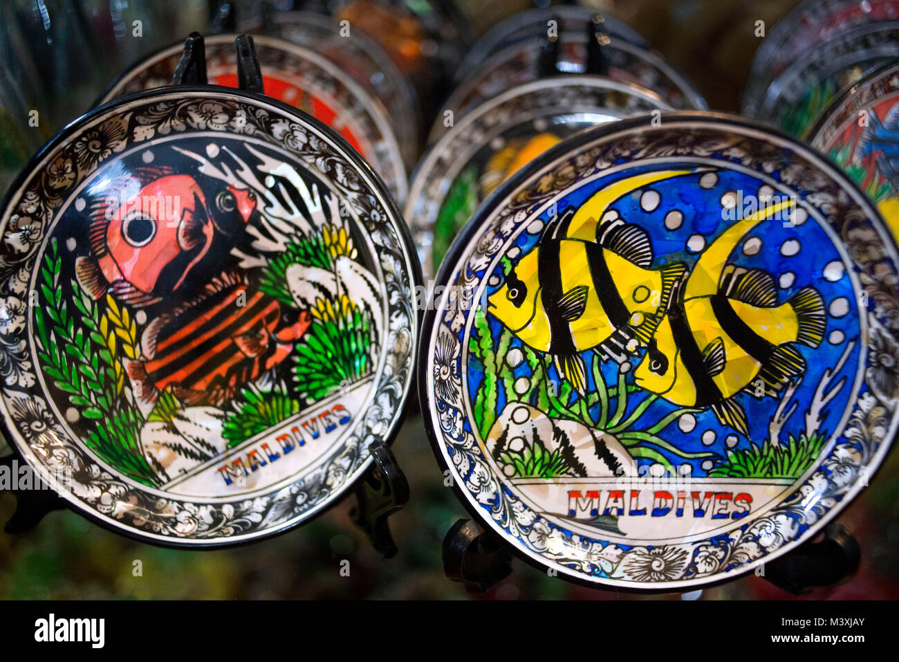 Paintings of Maldives island fishes as souvenir in dishes, Malè, Maldives Stock Photo