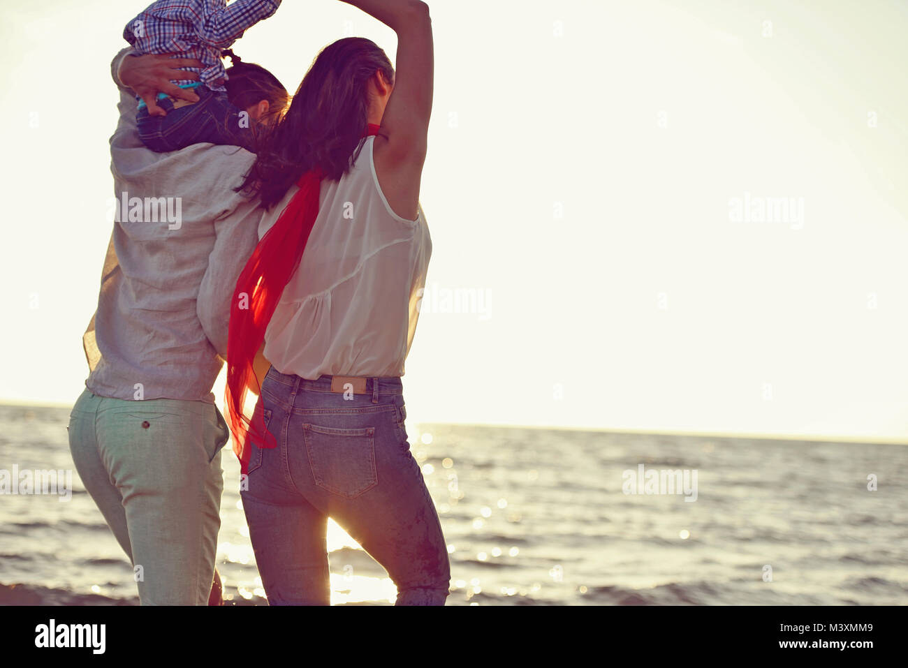 portrait of happy family and baby enjoying sunset in the summer leisure Stock Photo