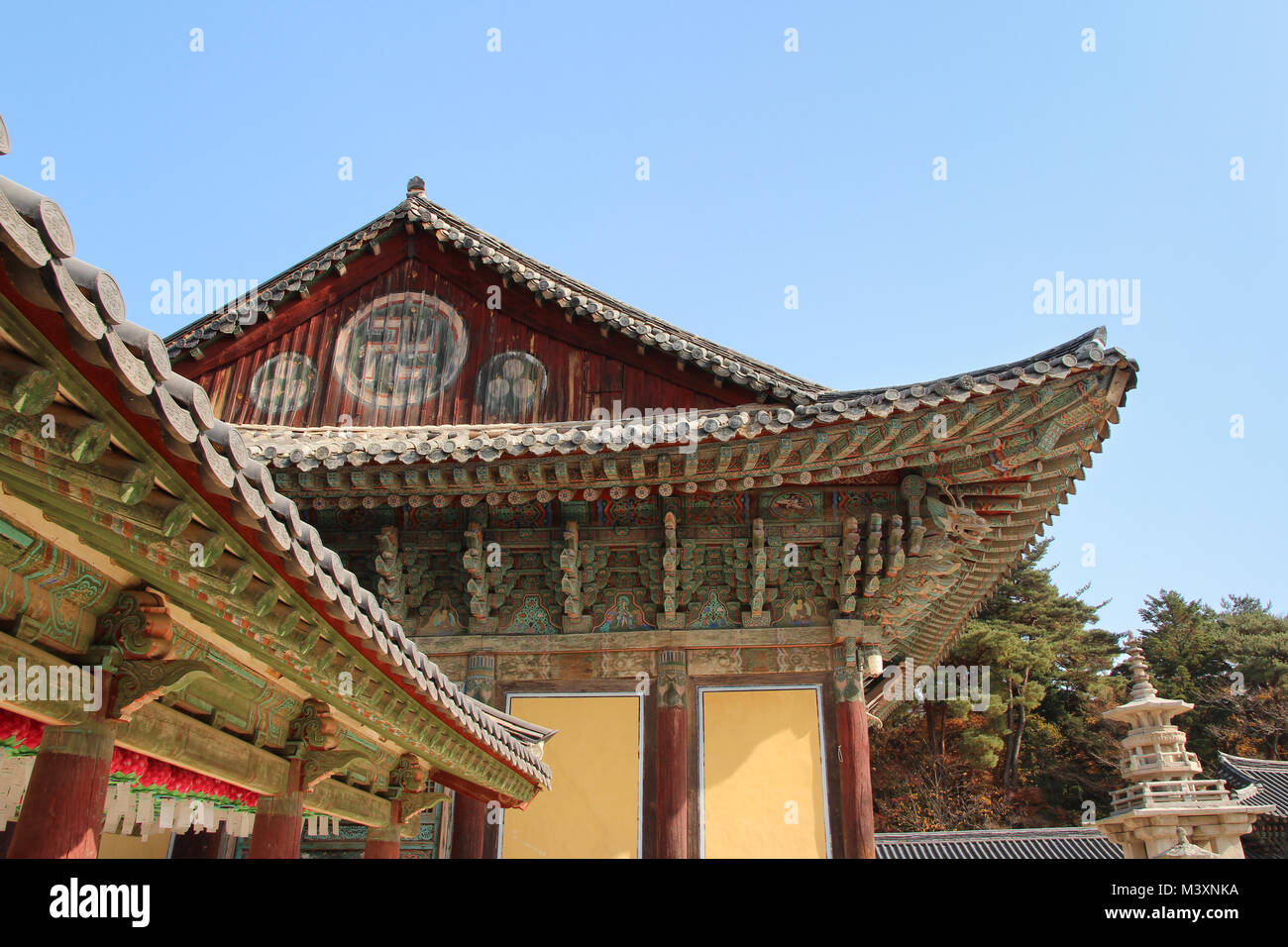 Korean traditional architecture detail of eaves with Buddha images at ...