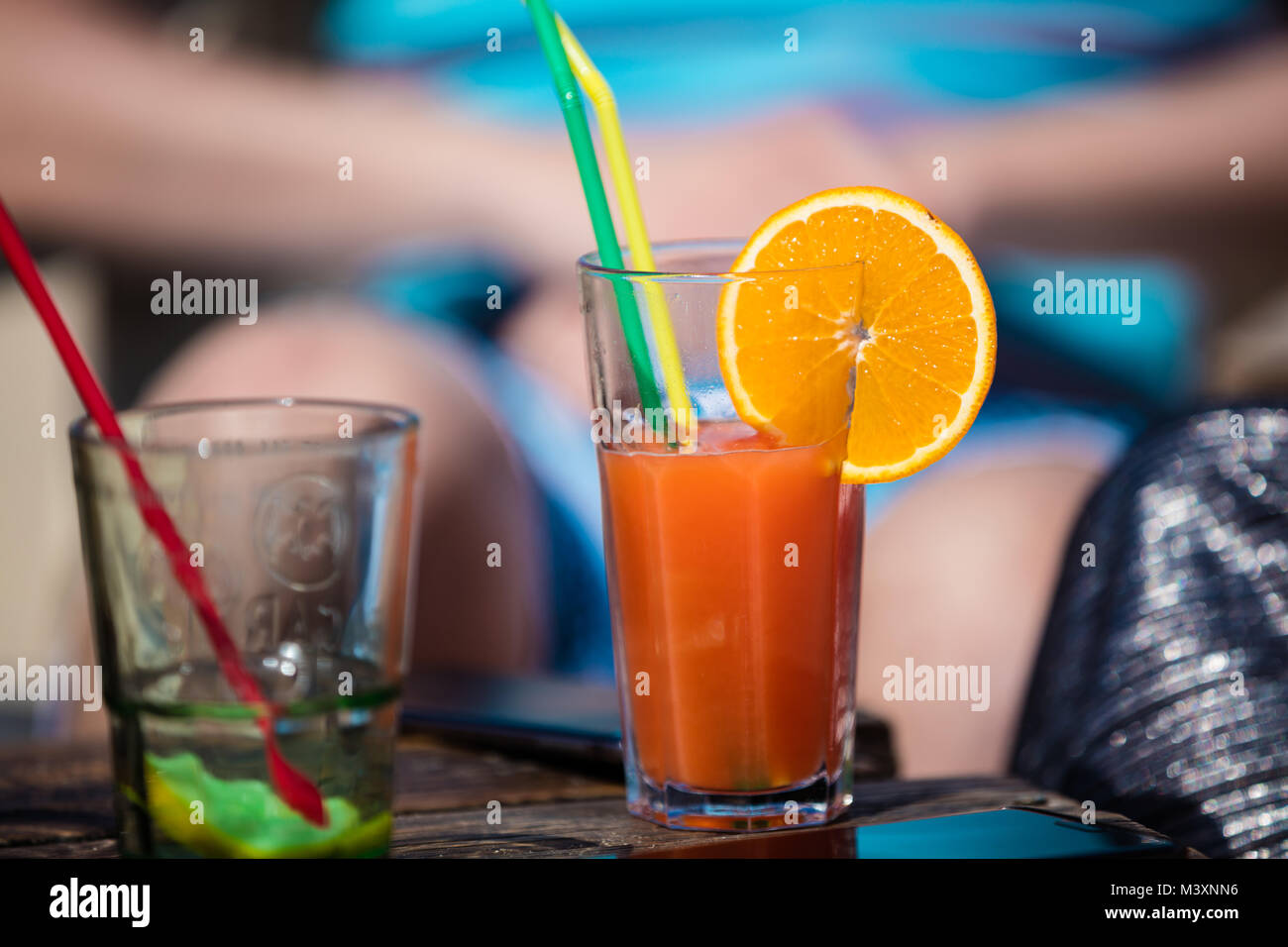 Alcohol orange daiquiri and mint cocktail on beach bar rustic wooden