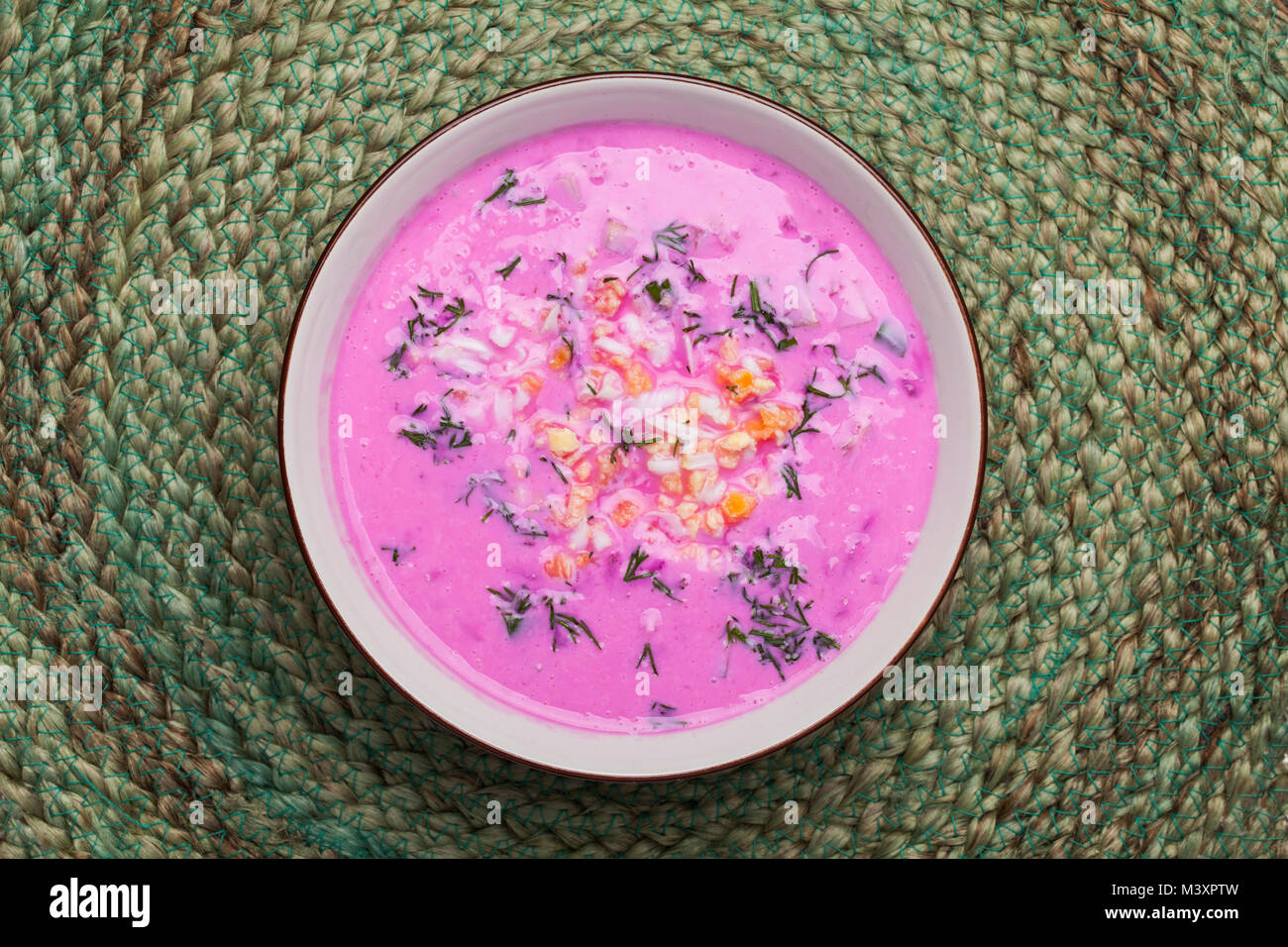 Traditional lithuanian cold beet pink soup, prepared of cucumber, beetrot, eggs and sour cream, called saltibarsciai Stock Photo