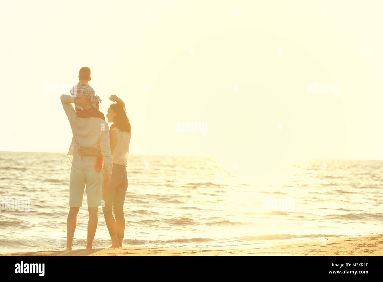 portrait of happy family and baby enjoying sunset in the summer leisure Stock Photo
