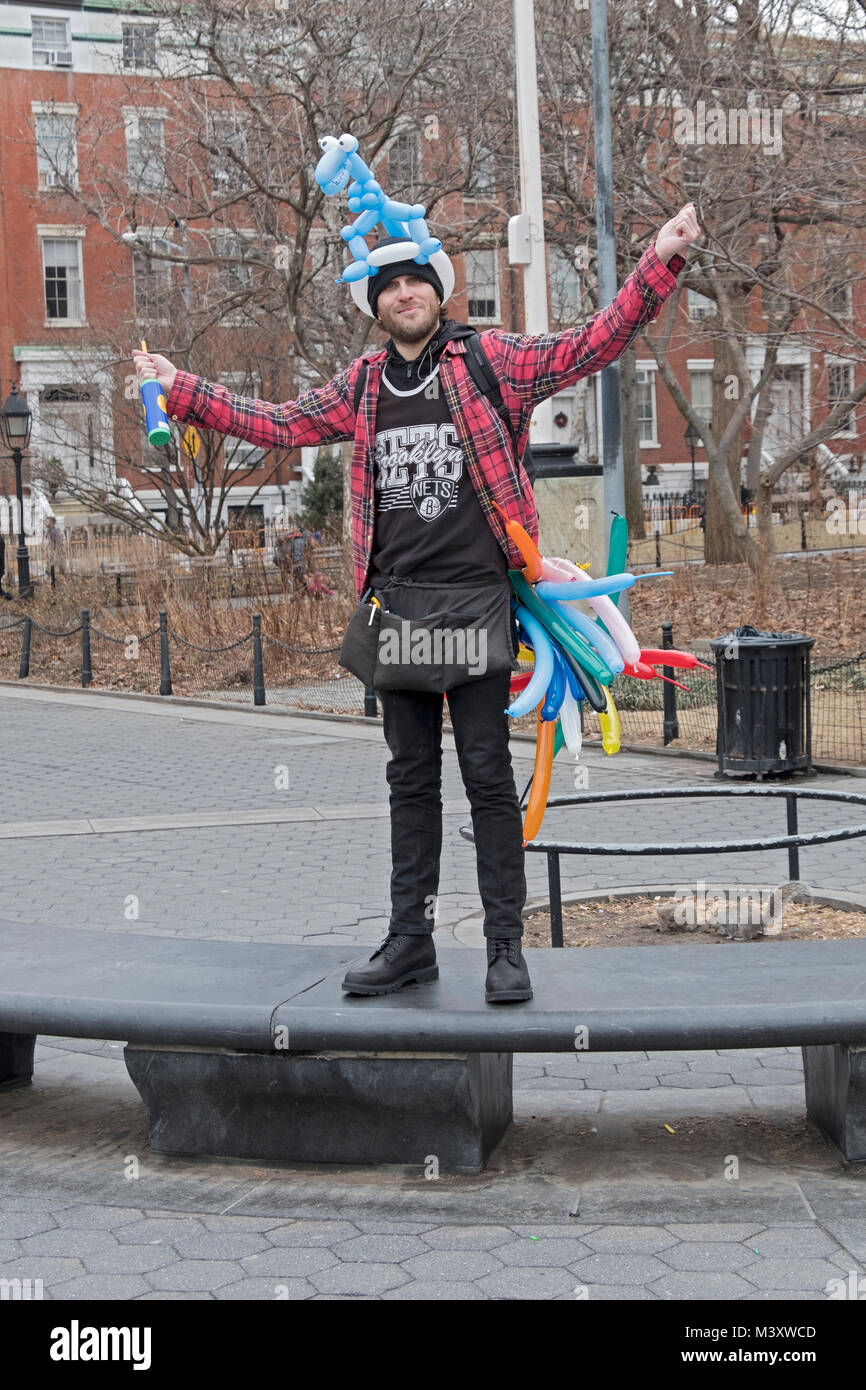 A young man who makes animal shaped balloons and solicits contributions in Washington Square Park in Greenwich Village in New York Cioty. Stock Photo