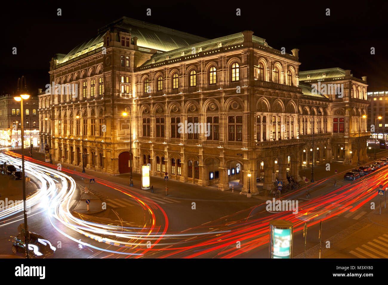 Vienna State Opera at night with car light trails on the Vienna Ring street. Stock Photo