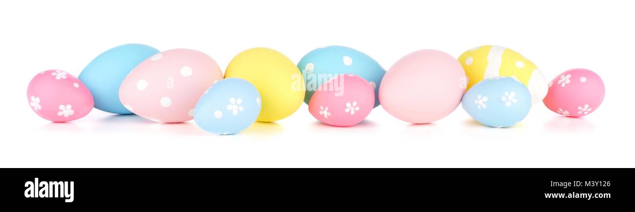 Easter eggs scattered forming a long border. Isolated on a white background. Blue, yellow and pink colors. Stock Photo