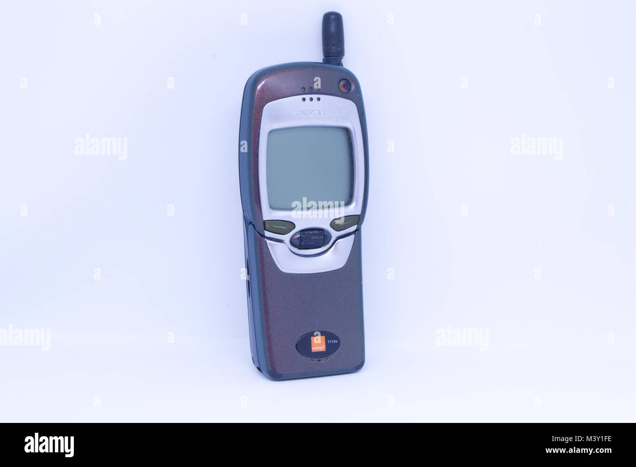 Old Nokia 7110 mobile phone with flip keypad pictured against a white background Stock Photo