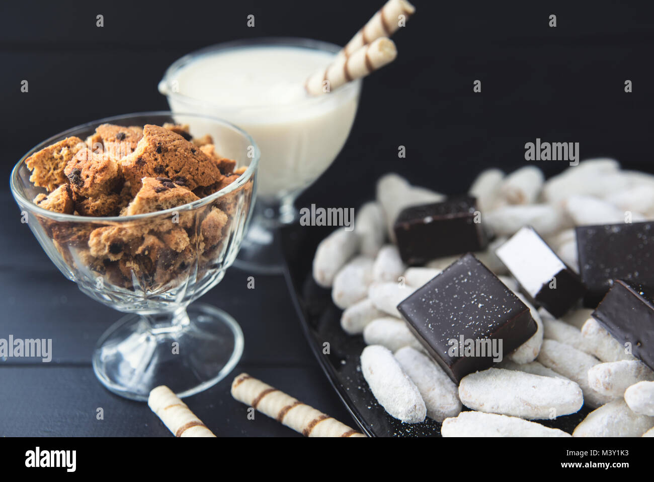 sweets, straws in the cream, cookies and candies on the table Stock Photo