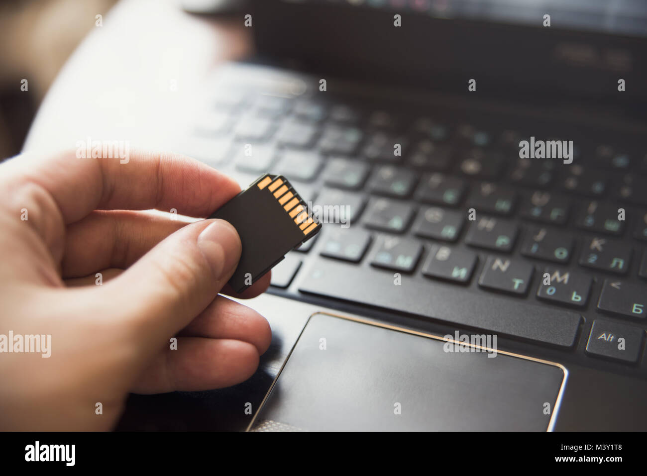 Stick in hand, laptop, keyboard flash drive information Stock Photo Alamy
