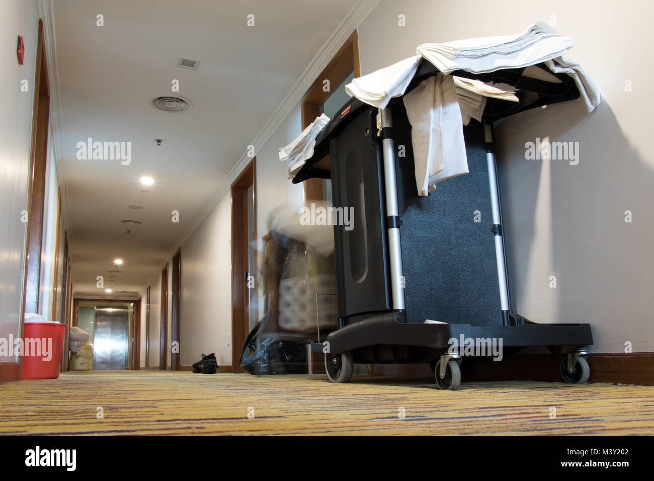 Empty hotel corridor with service trolley. Cleaning at the hotel. Stock Photo