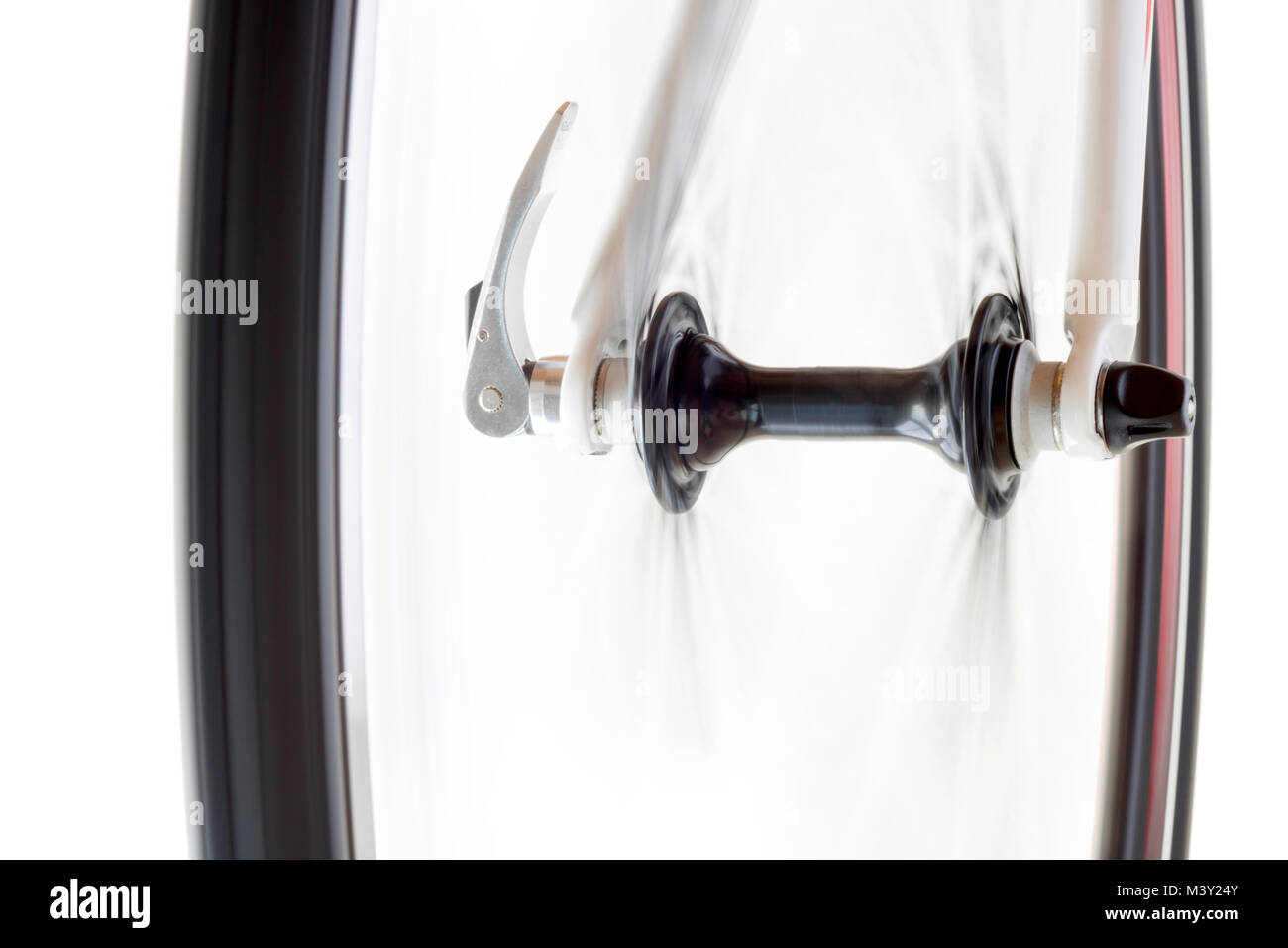 The front wheel of the bicycle rotates quickly on a white background