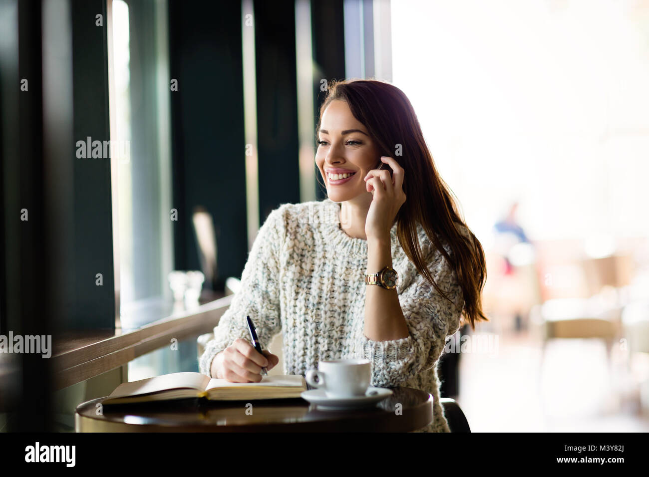 Portrait of happy young woman in cafe Stock Photo - Alamy